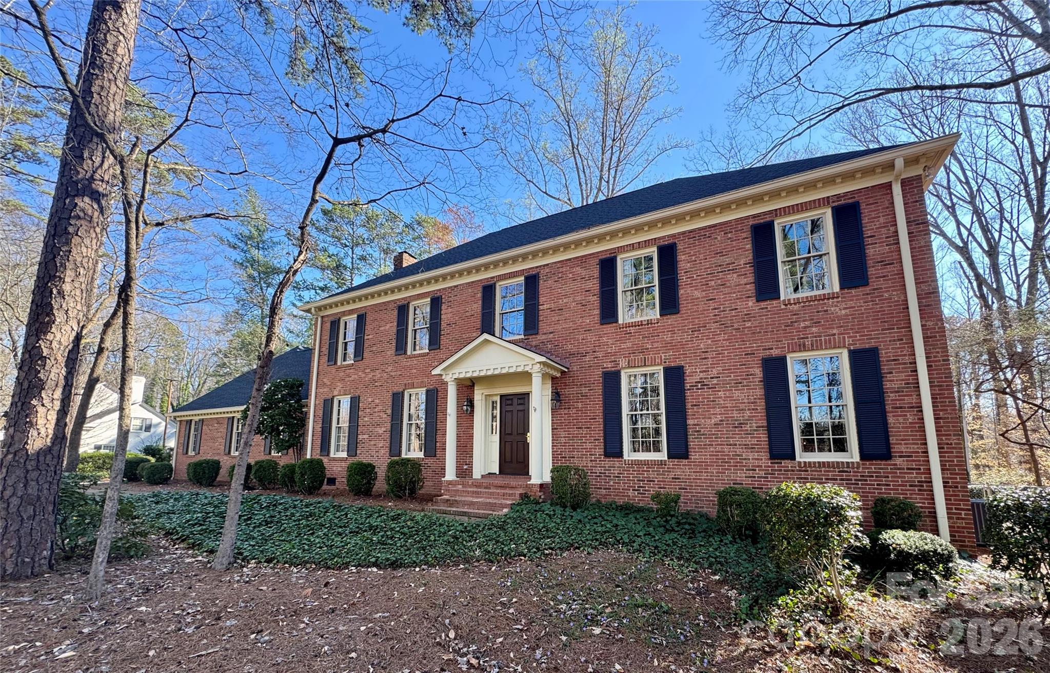 Step into this timeless and classic full-brick two story home located just minutes from Downtown Concord. Beautiful hardwood flooring throughout. The main level primary suite completed in 2020 features custom cabinetry for clothes, a spacious ensuite bath, and is the ultimate owners escape. The formal living room and dining room are perfect for large gatherings. The family room with built-in bookcases and wood burning fireplace is cozy but spacious. Enjoy cooking or entertaining in the well appointed kitchen with stainless appliances and an island with dark walnut countertop. There is a second bedroom on the main level that is currently used as an office. A second primary suite is located upstairs and has an ensuite bath with double vanity and dressing area. 2 additional large bedrooms with two closets each share a hall bath upstairs.  The walk-in attic space is massive and makes stored items easy to access. The basement is a perfect teen hang out area, home gym space or can be up-fitted to fit your needs. Oversized 2 car attached garage. Wired storage building-one side is used as a workshop and the other side is a potting area and storage space.  Brick patio for enjoying time outside or grilling. The home sits on approx .62 acres with mature trees behind it offering privacy at the end of Windsor Place. Close to I-85, Atrium Health Cabarrus and shops and restaurants, but tucked away in an established neighborhood.