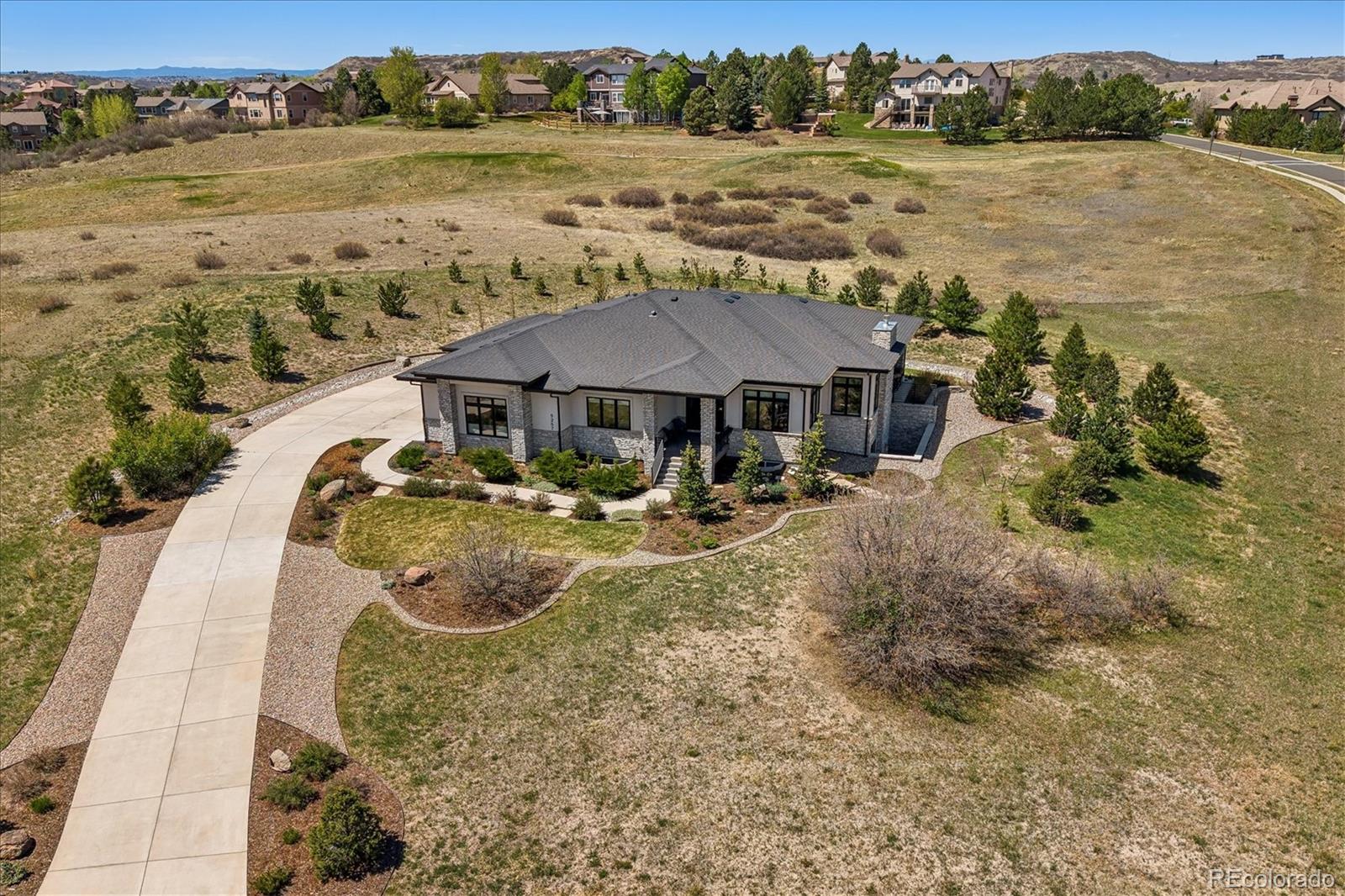 Near-new Custom Home and a modern-style masterpiece built in 2019!  Less than new after landscaping, window treatments, irrigation system, trees and plants, etc.!!! Verify for yourself and we are ready to go now - why wait? Modern style, bright, light and open. Large, private lot of 1.275 acres with exciting views out the front, side and rear of this enchanting home. The photos do not do this magnificent home justice. Enjoy sunrises and sunsets from the spacious rear patio and sunny windows. This is a very unique setting with some of the best views in the renowned Pradera Golf Club community. Private and quiet is assured here. The proud owners have completed the landscaping, gone overboard on planted trees,  finishing the basement, upgraded custom finishing touches throughout, window covering and more! This is move-in ready so why wait to build and then do landscaping window treatments, etc.? Kitchen and family room create one Great Room with large windows to bring in the outdoors. Enjoy the flexibility this amazing floorplan offers with one secondary bedroom and the primary bedroom on the main floor plus two more bedrooms on the lower level. The expansive game room on the lower level with a most impressive wet bar, fireplace and exercise area are to die for when it comes to children/entertaining having a great time. Ample space for pool table, working out, media area, hobby area and more. Note the raised ceilings on both lower levels for an even more spacious sensation!!! Drive your private golf cart two blocks to the renowned Pradera Golf clubhouse for a round, dinner or hit the driving range. Quick and easy access to shopping, hospitals, restaurants, highways, DTC, DIA, Park Meadows Mall and more. Pradera is in the middle of Parker and CastleRock.  This is a unique opportunity which rarely comes available in the area so do not miss out!
