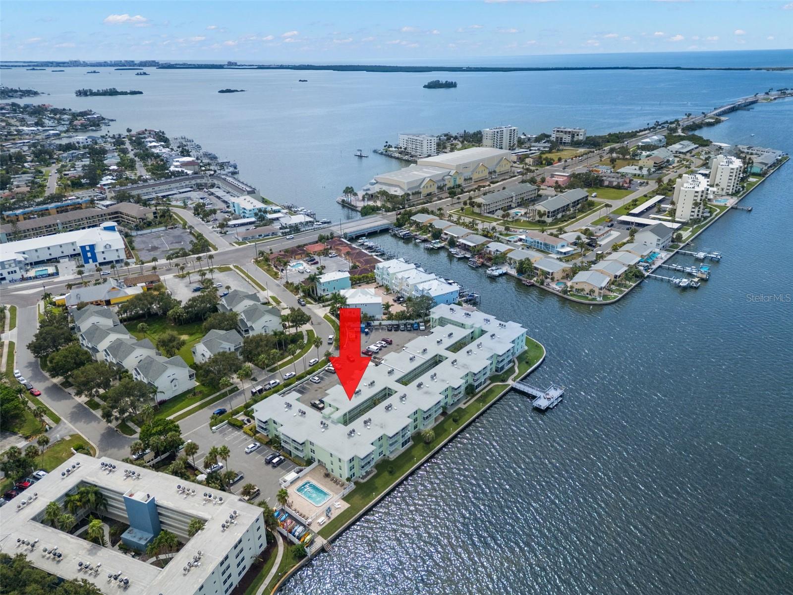 TURNKEY! Updated 2 Bedroom, 2 Bath Waterfront Condo in Dolphin Pointe, Dunedin. Discover your piece of paradise in the sought-after waterfront community of Dolphin Pointe, ideally located on the Dunedin Causeway just minutes from Honeymoon Island State Park. This updated 2-bedroom, 2-bath condo offers the perfect blend of comfort, convenience, and coastal living or utilize it as an income producing Monthly Vacation Rental as the current owners do. Inside you’ll find a split floor plan with a spacious primary suite featuring a king-size bed, walk-in closet, en-suite bath with tub, and its own TV. The guest bedroom offers a full-size bed, large walk-in closet, and easy access to a second full bath. The living area is light, bright, and decorated in a breezy beach theme, complete with a sofa that includes a pull-out bed, making this home truly move-in ready. Vinyl Planking throughout the Condo, except for Tile in the Primary Bathroom. Step outside to your private balcony to enjoy the fresh air and views of this waterfront community with a peek-a-boo view of the Water. Community Amenities include Heated swimming pool, Private fishing pier and dock with stunning sunset views, Kayak launch, Outdoor gazebo with grilling stations, Recreation room and picnic areas overlooking the water. Dolphin Pointe is walkable to restaurants, grocery stores, shopping, and the Pinellas Trail. Only a short bike ride or drive brings you to Downtown Dunedin, known for its vibrant dining, entertainment, farmer’s market, and boutique shops. This unbeatable location offers both everyday convenience and a true Florida lifestyle. One assigned parking space #49, and additional guest parking available. Community Locked Storage area included. Kayak storage rack spaces available for Rent. Community Laundry on the 1st Floor. Cable & Wi-Fi included with Maintenance fees. AC replaced August 2022. The Owners are selling the Unit furnished and activily rents the unit monthly with lucrative revenue. Minimum of one month rental. Milestone Inspection has been completed. Roof Replaced in 2024, exterior being painted before the end of 2025. Special Assessments have been paid.