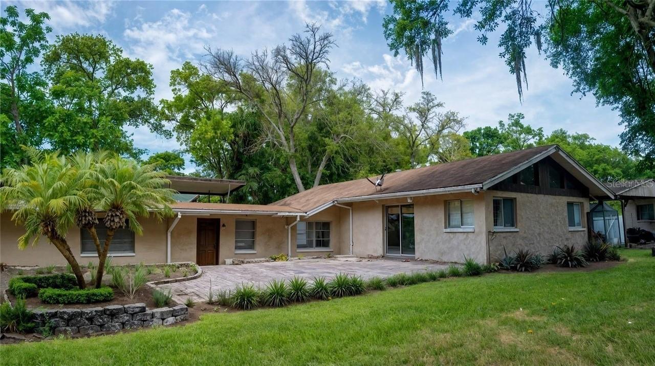 Set on 1.6 peaceful acres in the highly desirable Lake Mary area, this 3-bedroom, 2-bath home offers nearly 1,800 sq ft of comfortable living surrounded by mature trees and natural privacy. A private, gated 50-foot driveway leads you to a quiet retreat featuring a generous screened-in pool—ideal for entertaining or unwinding in total seclusion.The property includes a detached storage building with exciting conversion potential, along with an RV port and carport for flexible use of space. Inside, the home is simple, practical, and full of opportunity for updates or personal touches.Located within one of the region’s top-rated A-rated school districts and just minutes from 417, I-4, shopping, and Seminole State College, this setting blends everyday convenience with a rare sense of privacy.  Home is being sold AS IS.  TAKE ADVANTAGE OF THE $30,000 PRICE ADJUSTMENT!!!