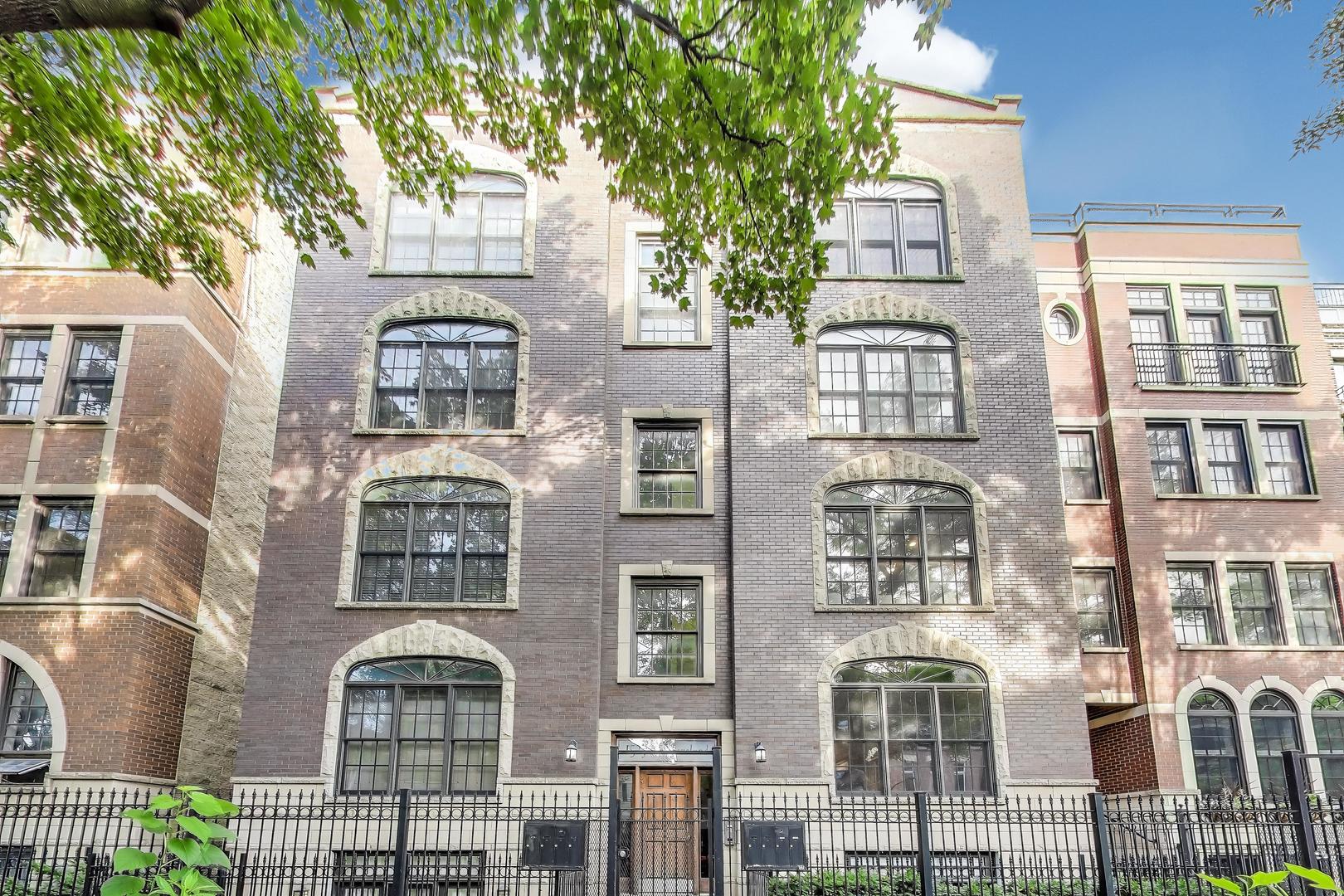 Gorgeous, extra-wide, and move-in ready condo, situated on a tree-lined street in a fantastic Old Town location. Enter into the wide foyer featuring a built-in bench with coat hooks and storage cubbies. The spacious open floor plan offers an abundance of natural sunlight. Beautiful hardwood flooring throughout the open kitchen, living room, dining room, and bedrooms, plus a true laundry space with side-by-side washer & dryer and extra shelving above. The updated kitchen features subway tile backsplash, white speckled granite, GE stainless steel appliances, a gas range with No Preheat Air-Fryer, a Bosch dishwasher, a wine fridge, and a Kohler Sensate touch-less faucet. The enlarged island with overhang for bar stools, coupled with plenty of room for a large dining table, makes this a perfect place to entertain. The living room features custom built-in shelving, a custom mantle surrounding the gas log fireplace, Hunter Douglas shades, and Sonance In-Wall speakers. The massive primary bedroom boasts a huge, fully customized walk-in closet with California Closet built-ins. The primary bath features double sinks with plenty of countertop space, marble flooring, a separate walk-in shower, and a jetted soaker tub. Enjoy the large east-facing deck off the primary bedroom, perfect for summer-time relaxing. The large second bedroom also includes a walk-in closet for extra storage. Covered carport parking included in the price, featuring a heated driveway. 2 blocks to Sedgwick Brown Line, walking distance to grocery stores, coffee shop, bars, restaurants, parks, and the Lake. Make this gem yours today!