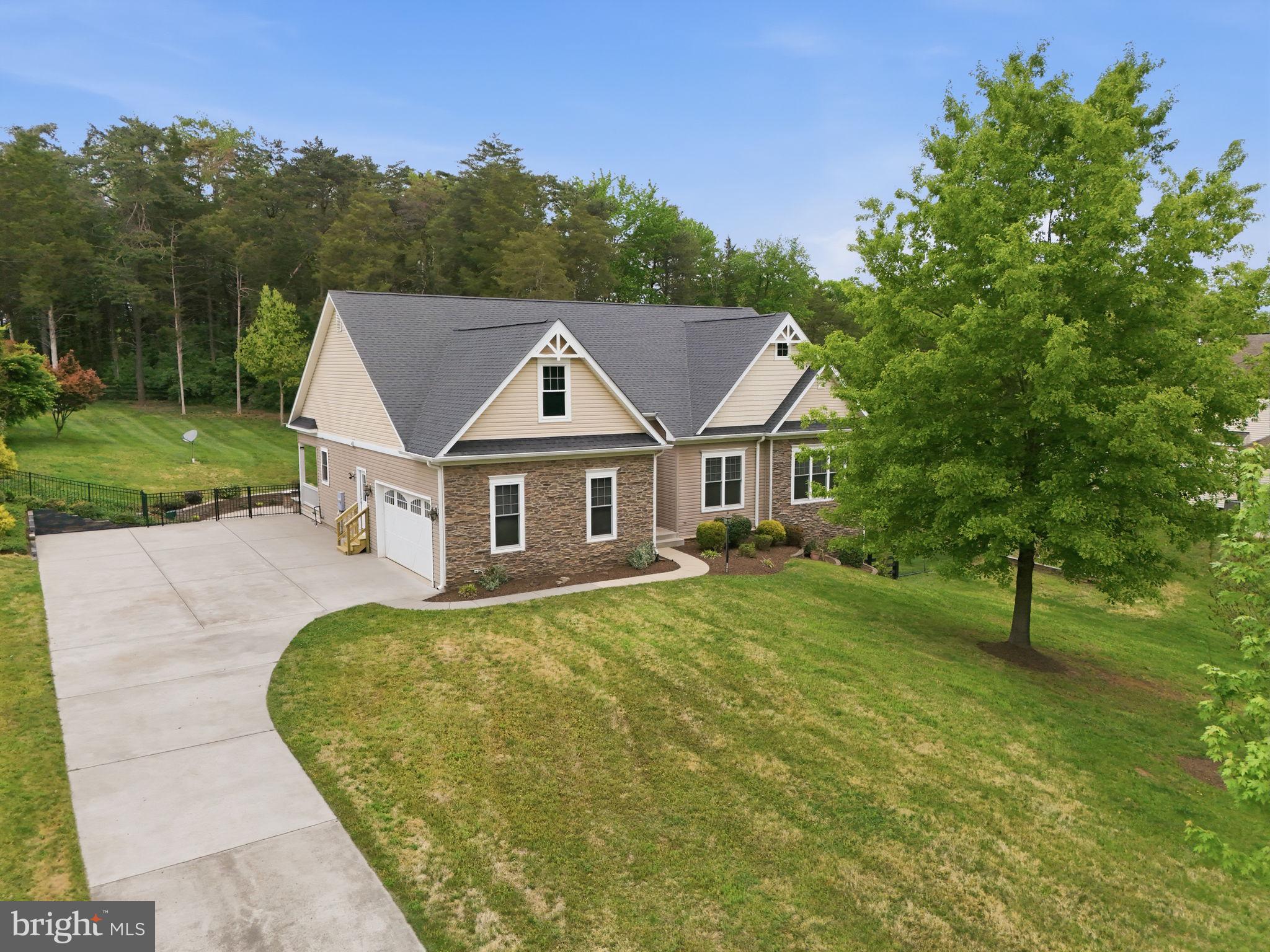 Welcome home to this custom-built residence, thoughtfully designed to offer a refined balance of comfort, functionality, and timeless appeal. Gracefully set on approximately 1.56 acres, with finished and unfinished space of approximately 4,482 square feet, the property enjoys a private backyard setting within a more open area, while remaining conveniently located near Route 50, shopping, dining, and commuter routes.Spanning approximately 2,241 square feet above grade, this home features first-level living and a well-conceived floor plan enhanced by 9-foot ceilings, wood flooring, and abundant natural light throughout. The main living area centers around an inviting open-concept Kitchen appointed with maple cabinetry and granite countertops, seamlessly connecting to the surrounding Living and Dining spaces—ideal for both everyday living and casual entertaining. A fireplace adds warmth and character to the main living area.The home offers 3 generously sized bedrooms and 3.5 bathrooms, providing comfortable and flexible living arrangements. Each space is designed with proportion and functionality in mind.Outdoor living is equally appealing, featuring a large patio and backyard porch that extend the living space outdoors, overlooking a private rear setting well-suited for relaxation or gatherings.The lower level includes approximately 2,241 square feet of unfinished and finished space with 9-foot ceilings, 1 full finished bathroom, and a side walk-out, offering substantial opportunity for future customization to meet a variety of needs.Additional features include a spacious concrete driveway and a 2-car garage, providing ample parking and convenience.This property presents a well-rounded opportunity for those seeking a home with thoughtful design and usable space.If the property is leased prior to May 18, 2026, this sale shall be contingent upon the tenant remaining in place through the expiration of their current lease term.Property is being sold strictly AS-IS.