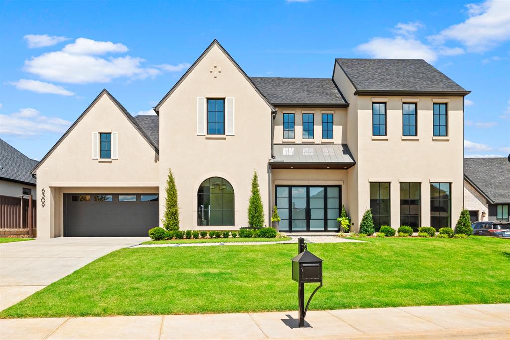 Just Completed September 2026! Enjoy sweeping water views, manicured landscaping, and endless blue skies framed by expansive panoramic windows in this exceptional new construction home! Nestled within the exclusive gated community of The Lakes of Annecy, this thoughtfully designed residence offers both luxury and convenience—just minutes from the Kilpatrick Turnpike, major hospitals, dining, and everyday amenities.Featuring a unique and functional layout, the home includes 4 spacious ensuite bedrooms (2 up and 2 down) 2 living areas, 2 dining spaces, and stunning study with floor to ceiling windows, beautiful paneling and beamed ceiling.  The gourmet kitchen features sprawling center island, exquisite custom cabinetry, and professional grade Thermador appliances. The dedicated Butlers Service area with beverage refrigerator and a spacious walk-in pantry offer exceptional storage. Privately located primary ensuite with exceptional view of the water features and stunning amenities. Enjoy seamless indoor-outdoor living with an outdoor kitchen and living area overlooking a tranquil water feature. High-end finishes are showcased throughout including stucco over brick, full foam insulation and epoxy floored 3 car garage.  Annecy is a small gated community and features walking trails along the creek and water features for a tranquil and scenic view.