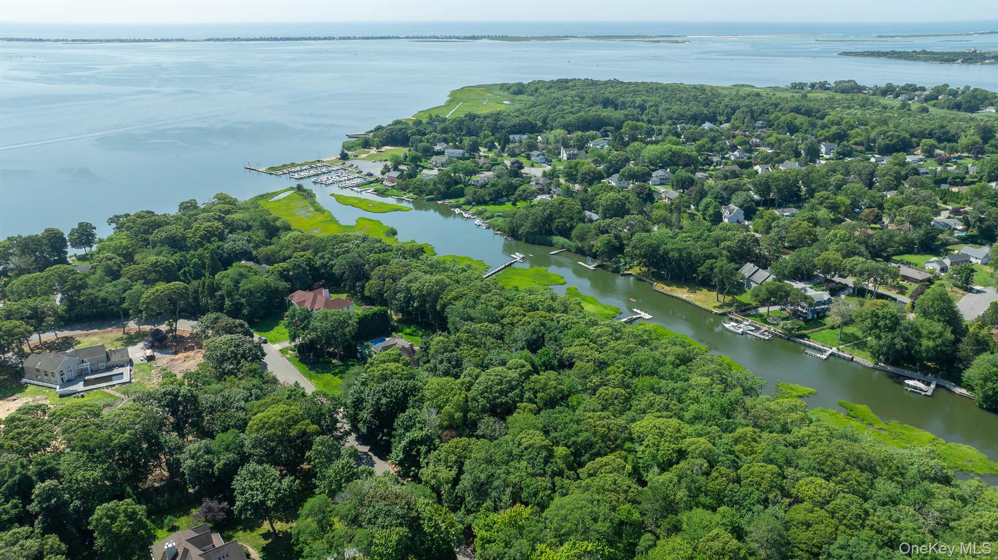 Nestled within the coveted Baywood community, this shy 2-acre waterfront property presents a rare opportunity to create a custom home in a beautiful and private coastal setting. With approximately 258 feet of waterfront, the property offers direct access to the water and the opportunity to design a residence that takes full advantage of the spectacular surroundings. Surrounded by mature trees, the property offers a peaceful sense of privacy while providing a picturesque backdrop for your future home. Imagine stepping outside to enjoy the water, setting out for a sunset boat ride, or taking in beautiful evening views from your own backyard.This exceptional parcel provides the ideal canvas for new construction, allowing you to work with a high-end builder to create a custom waterfront residence designed around your vision and lifestyle. Every detail can be thoughtfully planned to complement the natural beauty of the property and create a home that is uniquely your own. Residents of Baywood also have the option to join the homeowners association for $150 annually. Membership helps maintain the beauty and character of the community and provides access to the private community park, adding to the appeal of this sought-after waterfront neighborhood. 20 Inlet View Path (MLS #982849) and 22 Inlet View Path (MLS #982767) are each offered at $999,000, offering an exceptional opportunity to build a custom waterfront home in one of the area's most desirable communities.Inquire today to learn more about the property and available custom-build opportunities.