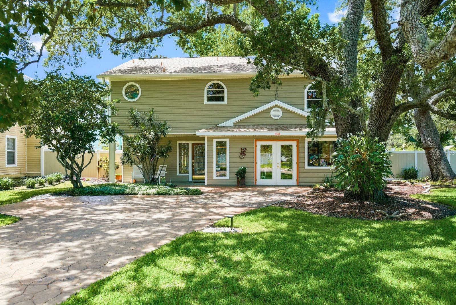 Virtually Staged. Rare opportunity to own a truly one-of-a-kind, character-filled home in the heart of Dunedin. Situated on a meticulously maintained corner lot, located outside of designated flood zones, and just half a mile from both Downtown Dunedin and the Pinellas Trail, this charming two-story residence, built in 2002, offers 2,016 square feet of thoughtfully designed living space with 3 bedrooms, 2 bathrooms, plus a dedicated office. The third bedroom is currently being utilized as a creative studio/workshop, offering flexibility to suit a variety of lifestyles.From the moment you arrive, you'll be captivated by the mature trees and lush landscaping that frame this exceptional property. Inside, timeless craftsmanship and artistic detail are woven throughout, including custom stained-glass windows, soaring ceilings with skylights, handcrafted tile work, historic art installations, and stunning entrance doors sourced from the early 1930s. Every space tells a story, creating a home that feels both warm and inspiring.Designed to embrace Florida's coveted indoor-outdoor lifestyle, the home features multiple huricane rated sliding glass doors that lead to an expansive 300-square-foot Trex patio deck perfect for entertaining, relaxing, or enjoying the coastal breeze.Major updates provide peace of mind, including a 2022 roof, central HVAC system with ducted heating and cooling installed in 2016, and a 2026 water heater equipped with a timer for added efficiency.Location is everything, and this home delivers. Enjoy easy access to award-winning restaurants, breweries, boutiques, festivals, waterfront parks, and all the charm that makes Dunedin one of Florida's most beloved coastal communities. World-renowned Honeymoon Island State Park is just minutes away, offering pristine beaches, nature trails, and breathtaking Gulf Coast sunsets.Combining historic charm, artistic character, modern outdoor living, thoughtful updates, and an unbeatable location, 755 San Christopher Drive presents a rare opportunity to own a piece of Dunedin's unique spirit.