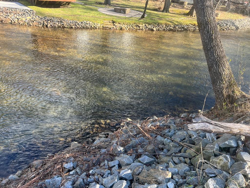 FLAT RIVERFRONT ACREAGE WITH MINIMAL RESTRICTIONS! This exceptional 5-acre property with frontage on the Hiawassee River is truly a fisherman's dream. The land is mostly level and offers minimal restrictions to protect your investment, with no HOA. RVs and campers are permitted with certain stipulations. Utilities are already in place, including electricity, public water, and an existing septic system-making this a ready-to-build opportunity. The property is located in a flood zone; however, fill dirt has already been brought in, allowing for construction on an elevated foundation. An 8x12 storage building is included with the sale for added convenience. Ideally situated just a short drive to shopping, dining, hiking, and popular mountain attractions such as Helen, GA and Brasstown Bald. This property is perfect for a riverfront getaway, full-time residence, or future dream home. Don't miss this rare opportunity to own flat, usable riverfront acreage with some infrastructure already in place!