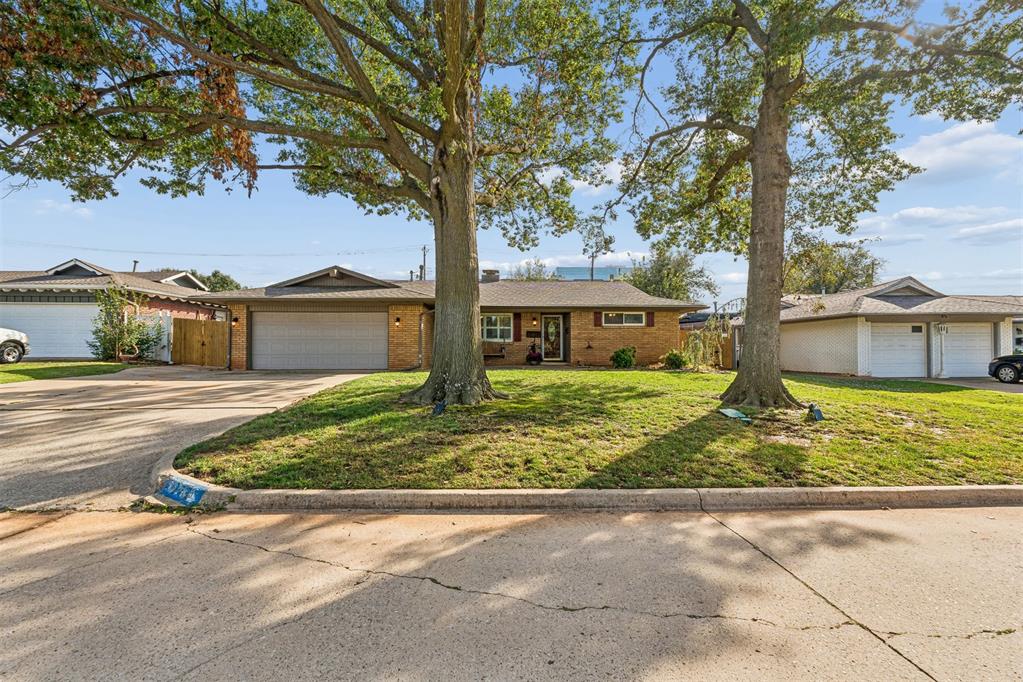 Welcome th 3724 NW 64th Street in Edgewater neighborhood in Oklahoma City. Featuring a distinctive mid-century-inspired design, this home offers two spacious living areas highlighted by a striking floor to ceiling sculptural mid century modern fireplace with a dramatic tapered hood. The open flow between the living areas and dining areas created a welcoming space for everyday living and entertaining. The kitchen features abundant cabinetry, generous counter space, and a functional layout. Renovated bathrooms and spacious bedrooms  are perfect for family and guests. Step outside to a large backyard and two expansive patio areas. One covered patio area and one fire pit patio area. This backyard is perfect for fall nights making smores, or early morning coffee. Come make 3724 NW 64th street your new home.
