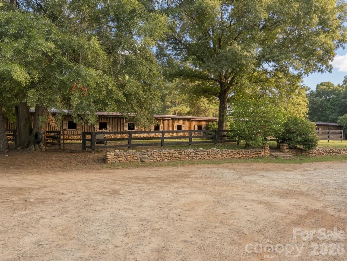 For the first time, Ly-Nard Hills Farm is offered for sale. There are places that hold more than land and buildings. Places that carry the quiet echo of hoofbeats at dawn, the soft murmur of coaching voices, and the laughter of riders who arrived as students and left as champions. Ly-Nard Hills Farm is one of those rare places.For decades this iconic farm has been home to a family whose passion for horses and people reached far beyond the fences. From these fields and arenas, show jumpers were carefully developed and Olympic-level equestrians refined their craft. The lessons taught here, the standards set here, and the kindness shared here touched thousands of lives across the country and around the world. Locally, the farm became a beloved gathering place—where community, mentorship, and lifelong friendships took root alongside the horses.Now the time has come for a new chapter. The main house offers four bedrooms and three and a half bathrooms, while a spacious guest house could be made into two separate homes as rentals—six bedrooms total one with a full kitchen and the other with a kitchenette. Back of property is a three-bedroom, two-bathroom home with pasture and two run-in sheds for horses. Nearby groom cabins with two bedrooms and two bathrooms complete the living accommodations, making the property well-suited for continued equestrian use or a private retreat. The barn features 34 stalls.This is more than a property. It is a living legacy offered for sale, ready for the next steward who understands that land this special is meant to be used, loved, and shared. The farm presents remarkable flexibility: continue as a premier horse farm, create a private family estate with equestrian amenities, develop a riding camp or educational program, or explore dividing portions of the land while preserving its character. Some of this acreage is also included in the listing for **9818 State Road Hwy 9**, offering additional options. The property also offers direct access to the CETA horse trail system, allowing riders to enjoy miles of scenic equestrian trails right from the farm.Sold as-is. Some owner financing is available. Campers and a variety of farm and equestrian equipment may be purchased separately, allowing a smooth transition for the next owner.This is a rare chance to own a piece of equestrian history—land that has shaped riders, built character, and created memories that still travel the world. The fences still stand. The arenas still wait. The next chapter is ready to begin.