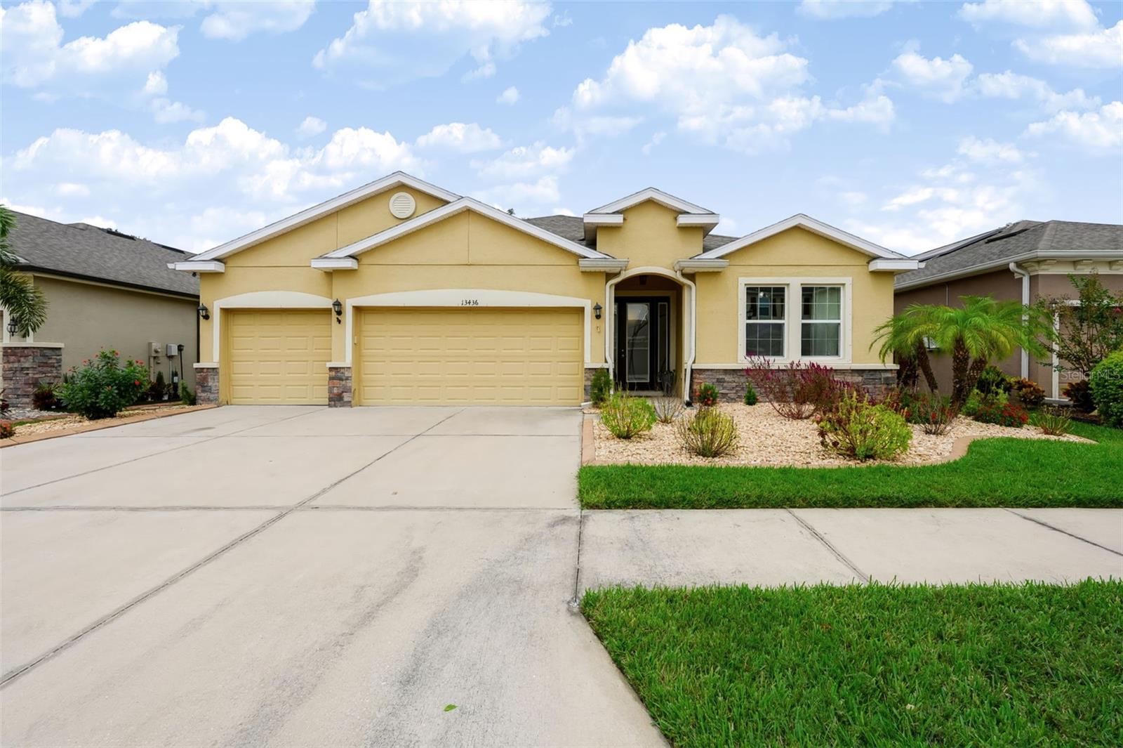Welcome to this beautifully maintained four-bedroom, three-bathroom home in The Creeks at Citrus Park, a private gated community in Tampa. This spacious home offers 2,368 square feet of comfortable living space and a three-car garage, combining an inviting layout with desirable features throughout. A welcoming foyer entry leads into the open floor plan, where crown molding, ceiling fans, and thoughtful architectural details add to the appeal. The spacious living room features a coffered ceiling and flows seamlessly into the kitchen, creating an ideal space for everyday living and entertaining. The kitchen offers granite countertops, stainless steel appliances, a large island with room for meal preparation or casual dining, and a walk-in pantry. The adjacent laundry room provides added convenience with ample cabinetry for additional storage. The spacious primary bedroom features a private en-suite bathroom with a dual-sink granite-top vanity, glass-enclosed shower, separate soaking tub, private water closet, and a walk-in closet with custom organizers. The additional bedrooms are nicely sized and offer flexibility for family, guests, or a home office. Step outside to the screened-in porch overlooking the fully fenced backyard, providing a comfortable space to relax and enjoy the Florida lifestyle. The property is nicely landscaped and offers a wonderful outdoor setting for enjoying the Florida weather. A 2026 water heater provides additional peace of mind. Located in the desirable The Creeks at Citrus Park community, this home is conveniently close to a variety of dining options, shopping centers, entertainment, parks, and major roadways, making it easy to enjoy all that the Tampa area has to offer.