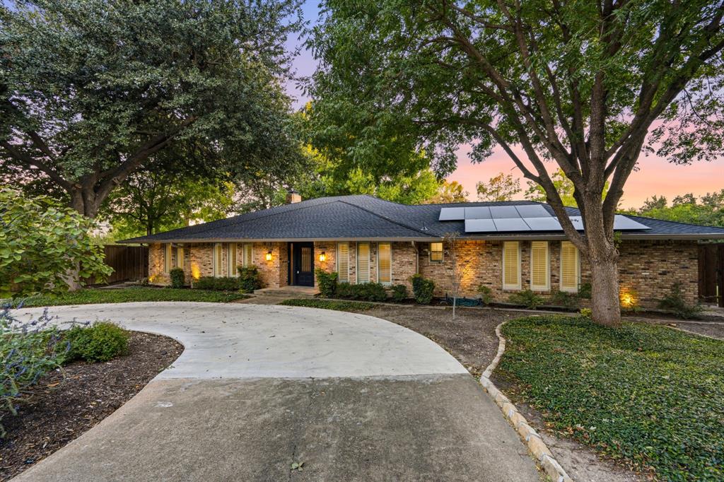 Welcome to 9656 Ravensway Drive, a completely remodeled, move-in-ready home situated on an oversized, beautifully treed lot in Dallas! Thoughtfully transformed with stylish finishes and modern amenities, this property offers the perfect combination of contemporary luxury, timeless architectural character, and exceptional indoor-outdoor entertaining. The stunning chef’s kitchen is the heart of the home, showcasing an expansive stone countertops, stainless steel appliances, custom cabinetry, and generous gathering space. Soaring vaulted ceilings, exposed wood beams, rich hardwood floors, and striking brick accent walls create an inviting atmosphere throughout the spacious living areas. An entertaining bar with dual beverage refrigerators adds style and functionality. The completely remodeled bathrooms feature beautiful vanities, updated fixtures, stylish tilework, and thoughtfully selected finishes. The spacious primary bath offers dual sinks, generous counter space, abundant cabinetry, and a separate soaking tub. Additional bathrooms showcase distinctive stone countertops, contemporary sinks, and custom tile details. Walls of windows flood the home with natural light and provide picturesque views of the mature trees and private outdoor setting. Outdoor entertaining is equally impressive, with an expansive patio, covered pergola, and multiple areas for dining, lounging, and gathering. The oversized lot provides privacy, with mature trees creating a peaceful, park-like atmosphere. Whether hosting a gathering or simply relaxing beneath the trees, this backyard offers endless possibilities. Completely remodeled and ready for immediate enjoyment, this home offers updated interiors, distinctive architectural details, and generous outdoor living without the hassle of renovations. Simply move in, unpack, and enjoy!