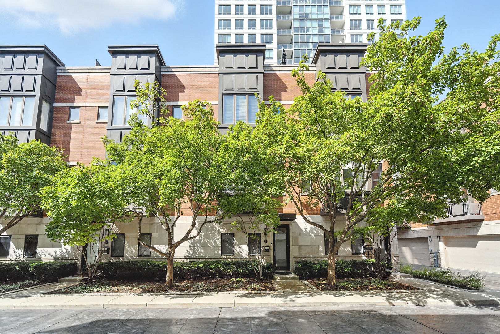 Stunning, sophisticated 3 bedroom plus den, 3 bathroom River North townhome in the coveted City Club gated community! This home is spacious, has a wonderful floor plan and lives like a single family home tucked away in the middle of River North! Thoughtfully updated and light-filled, this 4 level unit boasts stunning hardwood floors and 10 foot ceilings throughout. The ideal open floor plan is an entertainer's dream featuring a beautifully updated kitchen with 42" cabinetry, white quartz counters and backsplash, updated Subzero and Wolf stainless steel appliances, gracious island with breakfast bar, adjacent breakfast nook, walk-in pantry and generous sized balcony perfect for grilling with a Coyote gas grill installed and ready to go! Kitchen opens to a large dining space with built-in buffet and bright living room with gas fireplace, overlooking the tree-lined courtyard. The third level has a stunning king-sized primary suite with bay window, elegant custom walk-in closet, and grand en-suite bath with new quartz counter dual vanity, whirlpool bath, and oversized shower. Spacious second bedroom with custom closet and second full bath with quartz counter vanity complete this floor. The top level includes an enormous third bedroom with a giant walk-in closet, easily adaptable to a bedroom + den, along with a third full bath. Gorgeous rooftop terrace with spectacular city views! Lower level makes a perfect office/den/fitness room, with tiled flooring. 2 car attached garage, in-unit w/d and abundant storage throughout. All high-end modern appliances - Subzero/Wolf/Miele in the Kitchen, wine fridges, Samsung washer and dryer. Modern mechanicals, two AC units two Furnaces with smart thermostats. Light switches SmartHome capable. Steps from East Bank Club, Starbucks, Chicago CTA stop, Whole Foods, restaurants, shopping, and everything River North has to offer!