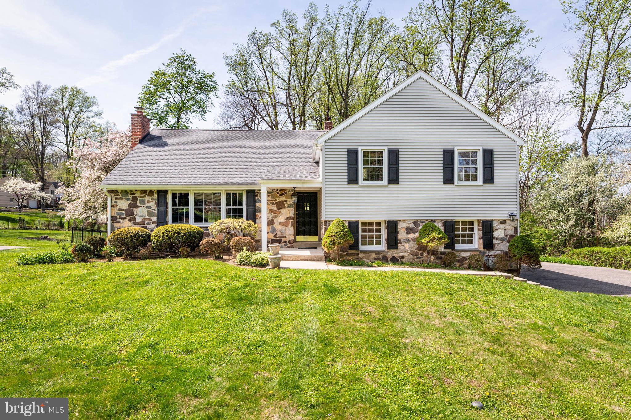 Discover the perfect blend of classic charm and walkability at 100 Wooded Lane, conveniently located in Villanova on Philadelphia’s Main Line. Set on a highly sought-after cul-de-sac street in the top-rated Radnor School District, this beautifully maintained 5-bedroom, 3.1-bath stone and siding Colonial split-level sits on a large, level lot in an idyllic community where homes sell quickly. This welcoming neighborhood is known for its friendly atmosphere where residents gather and children ride bikes in the cul-de-sac.The main level features an entrance foyer that opens into a spacious living room centered by a fireplace and a large front window that fills the space with natural light. Adjacent is the formal dining room, which leads directly to a serene screened-in porch—the perfect spot for enjoying views of the private, level rear yard or dining outdoors on summer nights. The kitchen is conveniently located off the dining room, offering a seamless flow and has space for a kitchen table. A rear door leads outback.The upper levels offer a versatile and spacious layout. The first upper level houses the primary suite with an ensuite bath, along with two additional bedrooms and a hall bath with a spacious vanity. Just a half-flight up, you will find two more bedrooms and a third full bath. One of these bedrooms is perfectly sized for a quiet home office. The other is being used as a bonus room and has a large closet. A storage room is located off the hall as well.The lower level (above grade) provides a comfortable family room, a powder room, and a side entrance leading into a mudroom/laundry room area, along with interior access to the attached 2-car side-entry garage. A crawl space in the garage offers storage.The ultra-convenient location is sure to please. This home offers incredible walkability—enjoy sidewalks to Starbucks, dinner at LaScala’s Fire, and the Villanova train station. Whether you are playing catch in the large yard, riding bikes in the cul-de-sac, or jogging the pathways of the nearby Villanova University campus, the lifestyle here is unmatched. With quick access to I-476 and the pedestrian bridge, 100 Wooded Lane offers a truly exceptional living experience in a premier Villanova community.