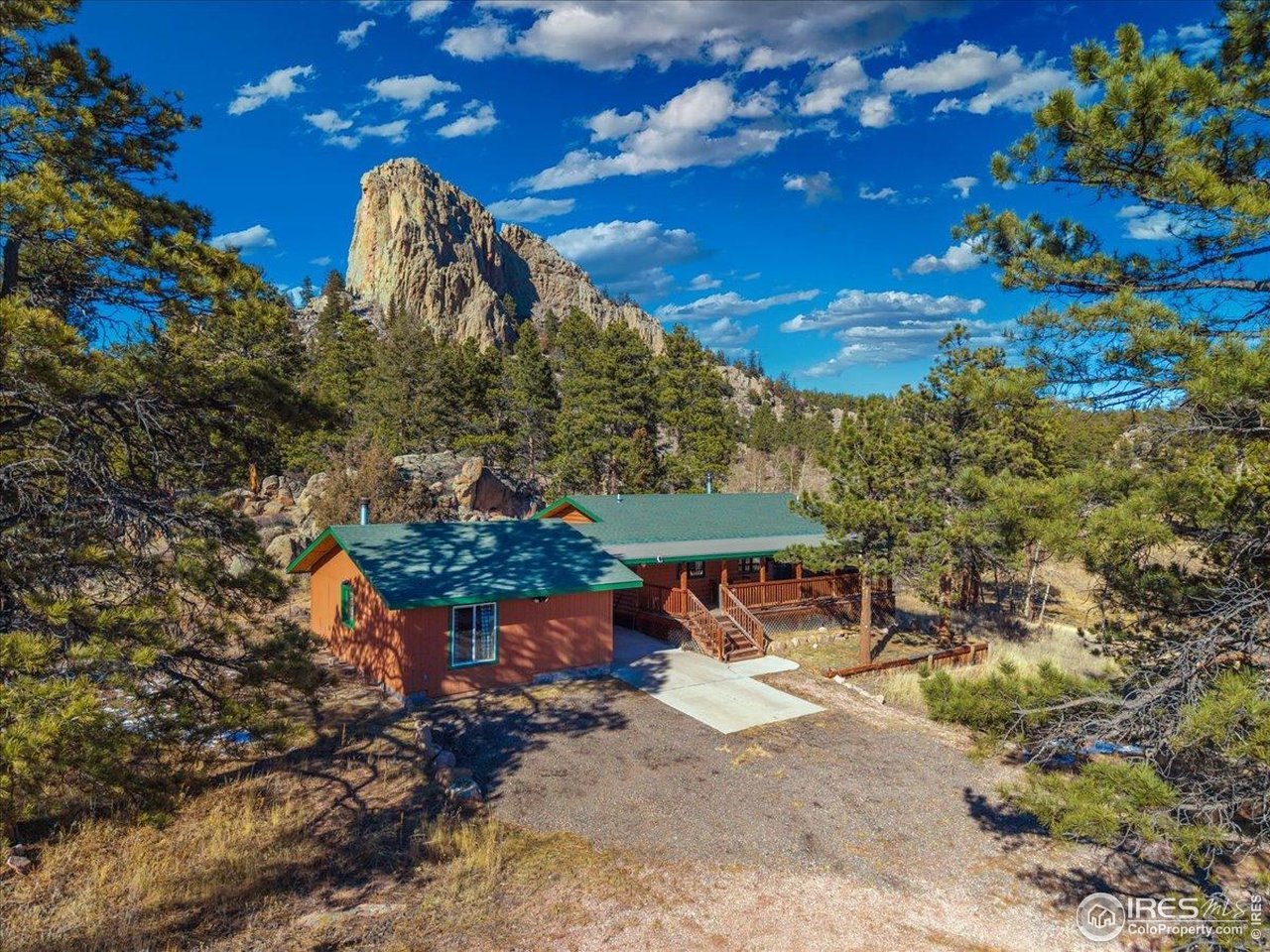 Rare Red Feather Ranch property with a beautiful home/cabin, detached flex space, huge shop, and proximity to Roosevelt National Forest! Experience true mountain living on 8.59 pristine acres featuring seasonal water and a small pond on property, with dramatic rock outcroppings nearby. This functional one-story ranch cabin offers an inviting open-concept living area, 2 bedrooms with built-in closets, and a tastefully updated bathroom. Enjoy the outdoors from the covered porch, which leads via a breezeway to a 520 sq. ft. flex space with electricity and a wood burning stove. The large 1,200 sq. ft. powered steel shop (built in 2017) with concrete floors and a large bay door offers flexible use for storage, projects and for your high country adventure equipment. With direct access to Roosevelt National Forest just steps away, this lush meadow property is the ultimate mountain escape or full-time residence.