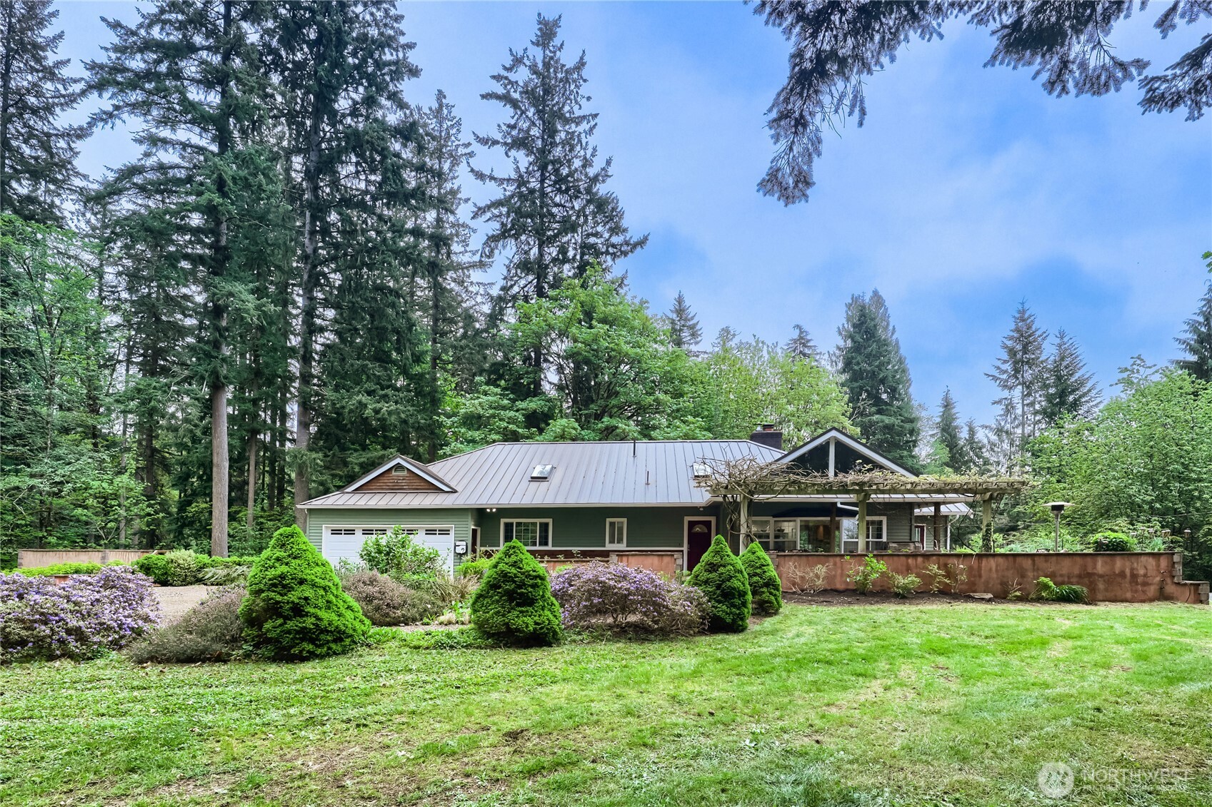 A rare Pacific Northwest retreat on nearly 8 private acres in the heart of Cherry Valley. Surrounded by evergreens, mountain views, and a stunning woodland garden, this one-of-a-kind property offers privacy, beauty & endless possibilities. Step outside to nearby trails leading to Cherry Creek Falls and enjoy nature right from your doorstep. The light-filled main home features skylights, French doors, and an open, inviting layout designed for comfortable living and entertaining. The chef’s kitchen with stainless steel appliances flows seamlessly to outdoor spaces, perfect for relaxing or hosting.The grounds feature a thoughtfully established food forest area, along with expansive usable land ideal for gardening, hobby farming, or equestrian use. Open space and natural surroundings offer flexibility for a variety of rural lifestyles.A true standout, the property includes two detached ~1,200 sq ft ADUs, offering exceptional flexibility for multi-generational living, rental income, or guest quarters. A large shop with double doors is perfect for car enthusiasts, projects, or storage, along with additional outbuildings for added versatility.Additional features include solar with battery backup, newer metal roofs, a fortified chicken coop, and a unique safe room or cedar-lined wine room of your dreams! A rare opportunity to own a private compound with room to live, grow, and thrive--all within easy reach of Duvall and the Eastside. Welcome home!