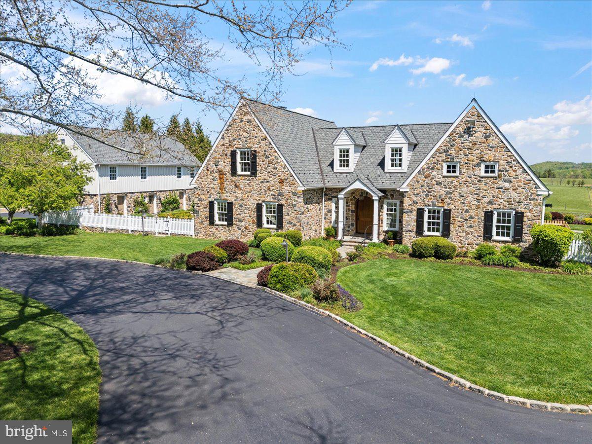 Nestled on a magnificent twenty-seven-acre parcel in the heart of Chester County, this exceptional private estate offers unparalleled luxury, privacy, and thoughtful craftsmanship throughout. Only the three to four acre building envelope is developed, with the balance of the land protected in perpetuity under a conservation easement held by the French & Pickering Trust—preserving the natural beauty and serenity of the surrounding countryside for generations. The main residence features three bedrooms and three full bathrooms across two floors, with extensive custom finishes and high-end systems. The heart of the home is a state-of-the-art luxury gourmet kitchen equipped with Sub-Zero appliances, a Viking 6-burner gas range, Miele dishwashers, two sinks, a massive side pantry with custom built-ins, and generous bar seating. It flows seamlessly into the incredible open-concept living and dining area, highlighted by elegant crown molding, a dramatic coffered ceiling, built-ins with TV in the living room, and a gas fireplace in the dining area. Multiple French doors open to a beautiful Pennsylvania bluestone patio, effortlessly blending indoor and outdoor living. A sunroom, beautifully renovated in 2016, features Bromic heaters and a stone-laid gas fireplace—creating a year-round retreat bathed in natural light. Additional main-floor highlights include a spacious mudroom with Pennsylvania bluestone flooring, built-ins, and coat closet; hot water radiant floor heating; a whole-house audio system; and extensive custom carpentry throughout. The spacious east-facing master suite offers remote-operated window treatments, French doors to the patio, built-in bookshelves, a huge closet, and a luxurious attached master bathroom with ceramic tile, a dedicated laundry area, a custom tile walk-in shower with glass surround, a comfortable soaking tub, and a bidet. A custom curved railing leads upstairs to two additional bedrooms, an office/workout room, and a full bathroom with a glass-enclosed shower and a tub. Additional luxury amenities include a detached 3-car garage with complete guest quarters on the second floor—featuring a huge bedroom, full bathroom, laundry room, kitchenette, and spacious living/dining area. Outside, the grounds are equally impressive. Extensive hardscaping includes Pennsylvania bluestone sidewalks, a stunning courtyard with meticulous landscaping, and a huge wrap-around patio offering breathtaking eastern views. The backyard is a true resort-style oasis, centered around a 50-foot by 18-foot heated (propane) pool with an electric cover that operates at the push of a button. The pool house includes built-ins, a bathroom, and a separate shower. Completing the estate is a greenhouse for the gardener extraordinaire, and a massive 2-story barn with two Schweiss bi-fold doors on either side and over 5,000 square feet of storage space for tools, equipment, vehicles, and hobbies.  This rare combination of refined luxury living, resort-style outdoor amenities, and protected acreage in a desirable location makes 182 Trythall Road an extraordinary opportunity. A true legacy property in one of Pennsylvania’s most scenic areas.