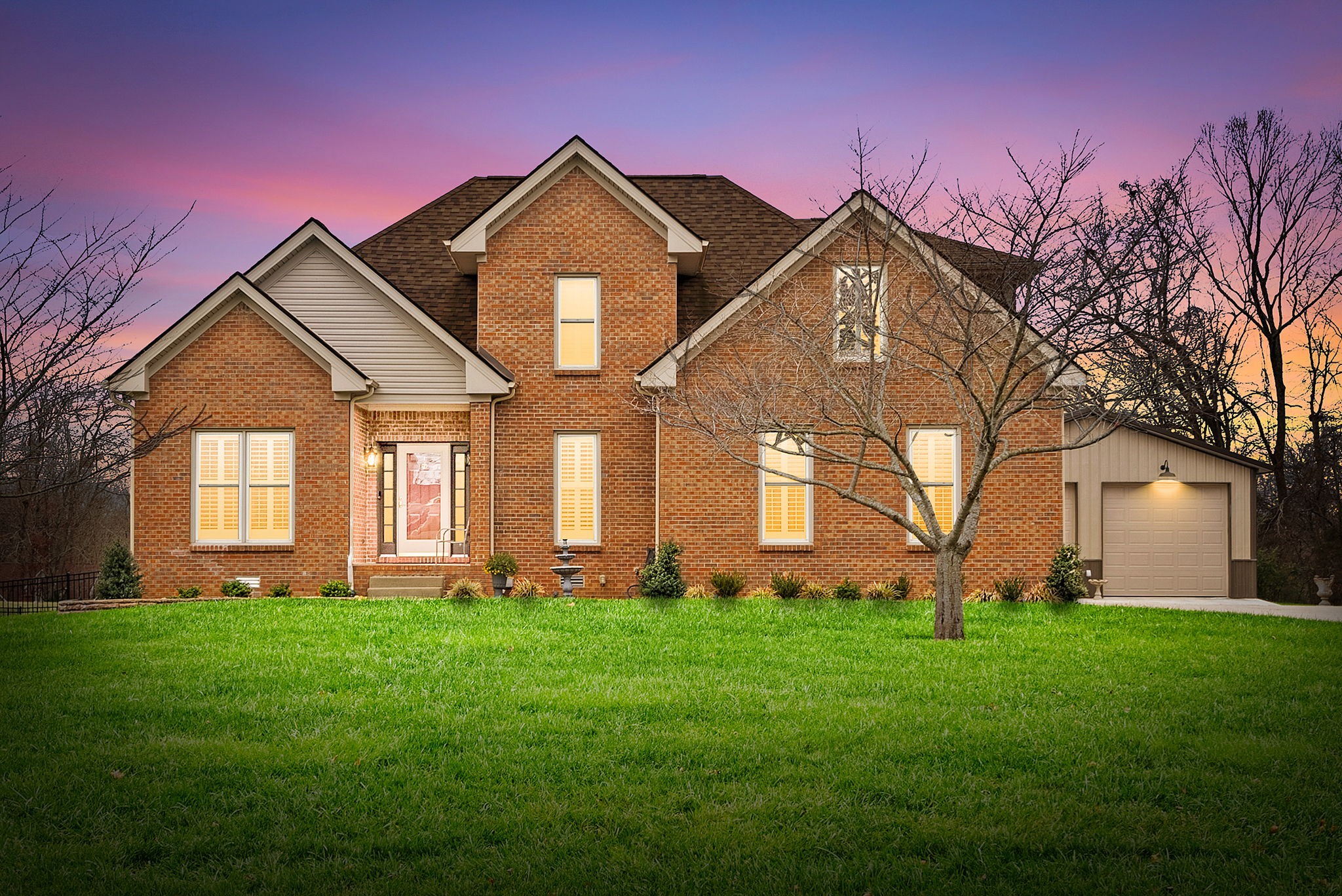 Updated move-in ready, full brick, 4 bed, 2.5 bath home located in the desirable Bradbury Farms neighborhood! The living room features beautiful wood floors, vaulted ceiling and a cozy fireplace, perfect for relaxing. The gourmet kitchen boasts upgraded cabinetry, granite countertops, stainless steel appliances, a spacious island, and a built in workspace. The primary bedroom is located on the main level and features a large walk in closet and ensuite bath with separate tub/tiled shower and large vanity with dual sinks. 3 additional bedrooms and a full bath located upstairs. If you need a home that offers plenty of storage space, be sure to check out the attached 2 car garage AND detached 32X26 garage/shop, equipped with heat/air, offering you plenty of space for vehicles and all sorts of toys and equipment! You'll surely enjoy the outdoor space as well. This home sits on almost an acre of land, and has a spacious screened in back deck with a beautiful stone fireplace; a space you'll be sure to enjoy year round!