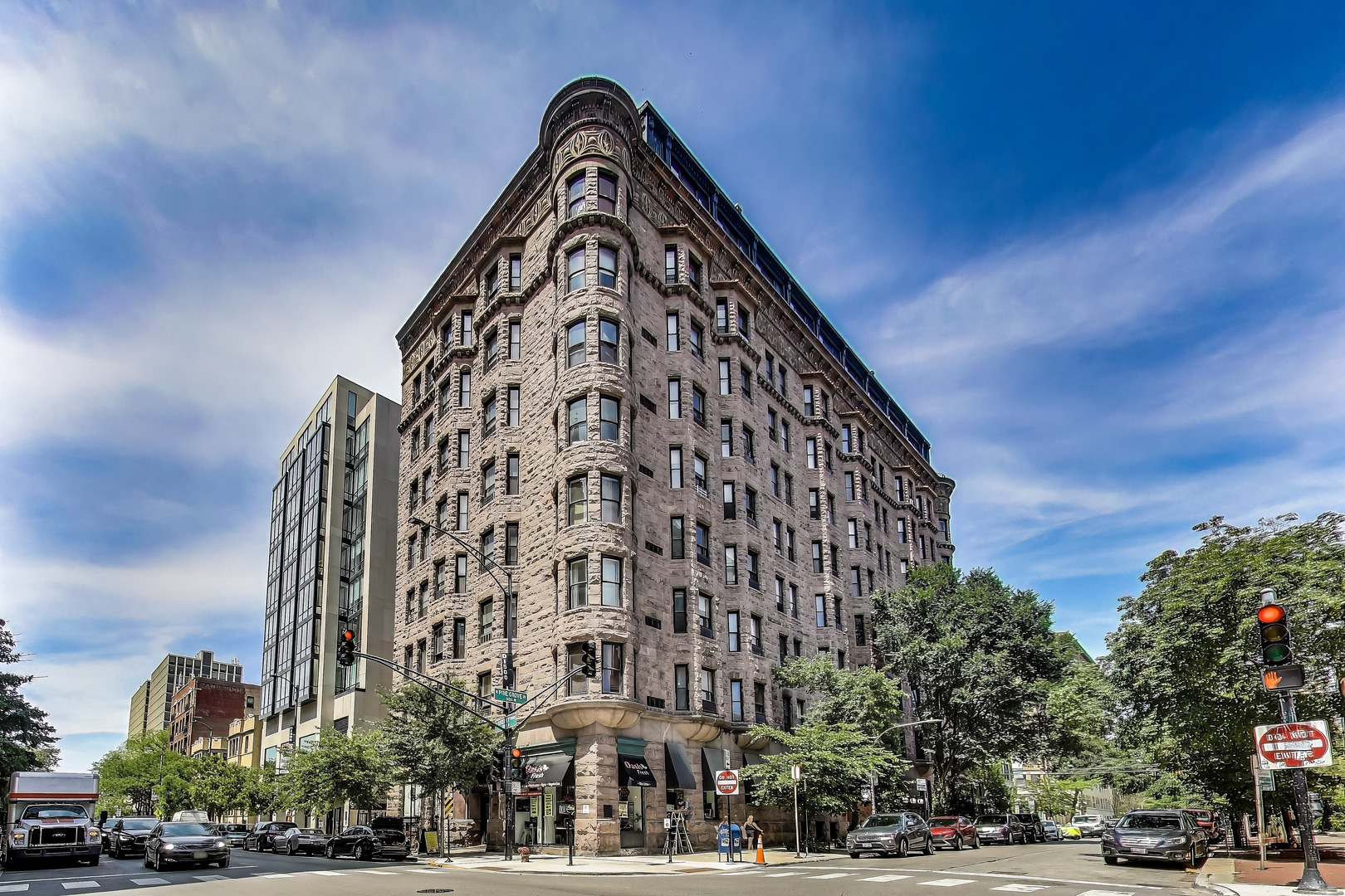 Iconic Landmark Living in Lake View East - Perched on the top floor of the historic Brewster Building, this completely remodeled 2-bedroom, 1-bath condo blends timeless charm with sophisticated modern updates. Soaring 10-foot ceilings and sunny eastern exposure fill the space with natural light, offering glimpses of Lake Michigan and surrounding architectural treasures. The stunning open-concept kitchen is a showstopper-featuring a full Bosch appliance suite, Quartz Calacatta Montage countertops, Studio41 Omega custom cabinetry, undermount lighting, and a vented hood/range. The spa-like bath has been reimagined with a floating frameless glass shower panel, floor-to-ceiling subway tile, striking ebony hexagonal floor tile, Kohler fixtures, and a new modern vanity and toilet. Other notable upgrades include: All-new plumbing and electrical, Wide-plank light oak flooring with soundproof underlayment, New Pella windows, Tankless hot water heater. This unique residence is housed within one of Chicago's most architecturally significant buildings, featuring a stately rusticated stone and terra cotta facade, stunning internal iron staircases, a European-style cage elevator, glass-block catwalks, common laundry facilities, bike room, storage, and on-site management with door staff. Located in vibrant Lake View East, you're just steps from shopping, dining, entertainment, public transit, and the lakefront. Don't miss your chance to own a piece of Chicago history with all the comforts of modern living.