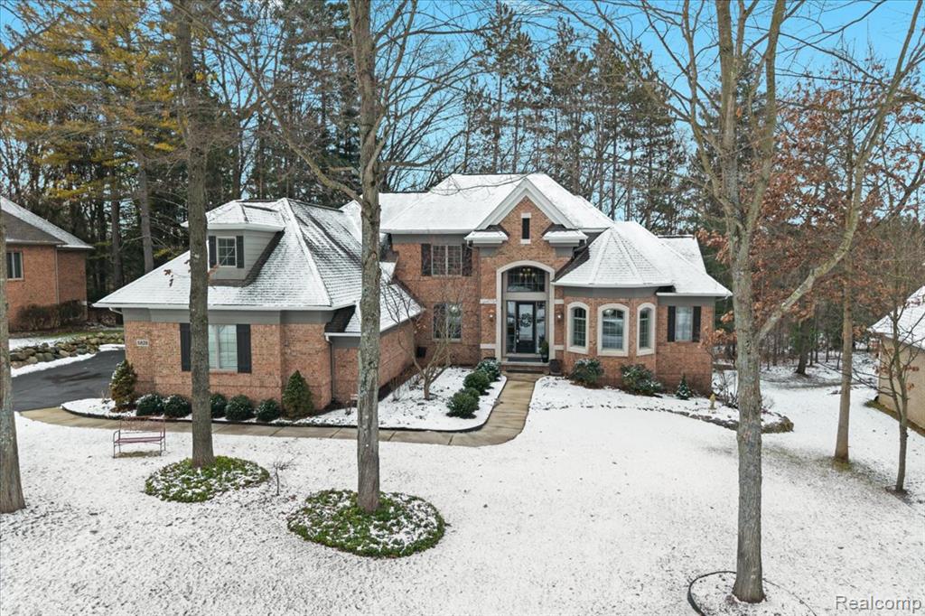 Exquisite home located in the prestigious Pine Creek Ridge, just minutes from downtown Brighton. This stunning HOME offers 5 bedrooms, 4.5 bathrooms, and 9-foot ceilings throughout. Enter the HOME into an elegant foyer with an open view to the impressive two-story great room featuring custom architectural ceiling and floor-to-ceiling windows that frame serene, private wooded views.Gorgeous hardwood floors flow through the main level, complemented by a den with bay window and custom built-ins, an open dining space with designer finishes, and custom lighting throughout. The first-floor primary suite is a true retreat with 11 foot double tray ceilings with custom, elegant lighting.  The ensuite featuring dual sinks, a spacious walk-in closet, a jetted tub, and a custom-tiled shower.  A true retreat for any homeowner.  The grand kitchen offers beautiful views and is equipped with premium Wolf, SubZero, Asko appliances and opens to a cozy hearth room highlighted by a two-way gas fireplace, ideal for everyday living and entertaining. Upstairs offers three spacious bedrooms one with an adjacent bathroom and another full bathroom and a versatile loft.The finished walkout lower level will continue to WOW you with expanded living space and includes a fifth bedroom and bathroom, a sleek bar, gas fireplace, and generous areas perfect for entertaining, guests, or multigenerational living.Step outside to a private backyard surrounded by towering pines, offering a rare sense of seclusion and tranquility. The wooded setting creates a true “Up North” feel, making it the perfect backdrop for morning coffee, evening gatherings, or peaceful relaxation—all while remaining close to all the wonderful dining, shopping, farmers market, festivals, etc. downtown Brighton has to offer. Enjoy living in this highly desirable neighborhood offering lake privileges on Brighton Lake, along with a clubhouse, pool, and tennis courts.  This is a HOME you will be proud to call HOME!