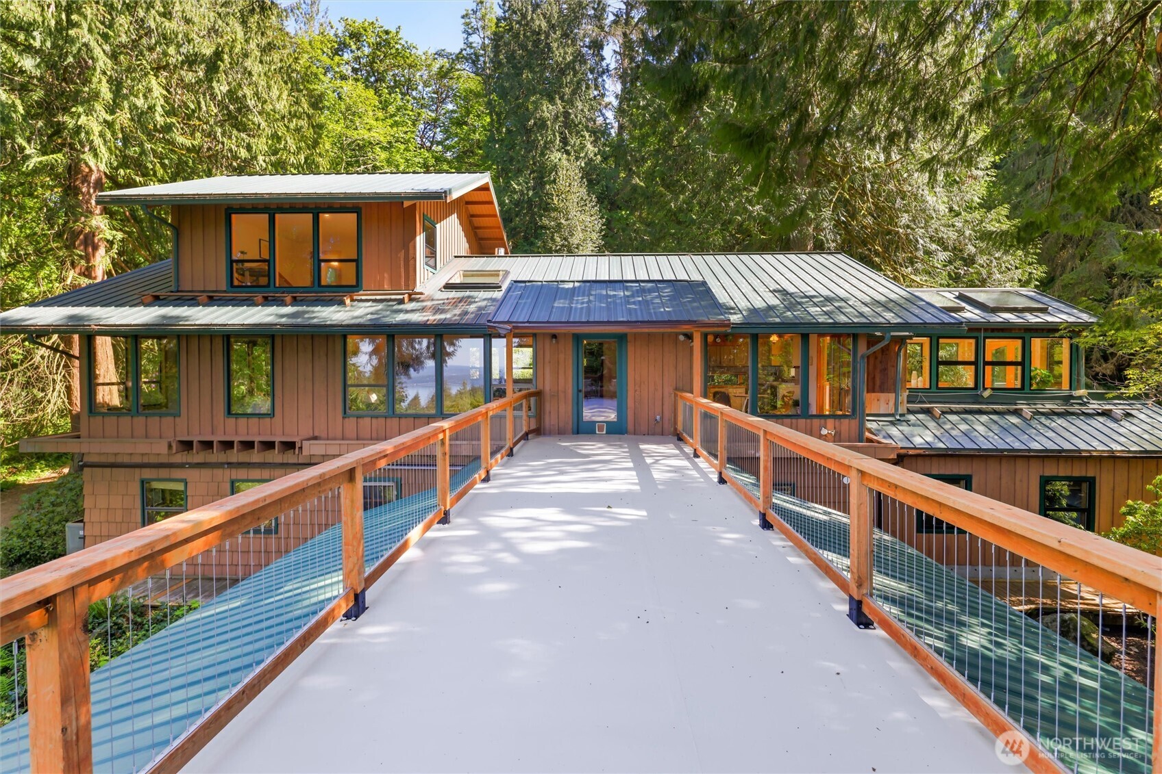 Step into your own Swiss Family Robinson–inspired retreat, where everyday living feels like a peaceful escape high in the trees. Perched atop Cougar Mountain & nestled within the tree canopy, this one-of-a-kind property offers the serenity & seclusion yet keeps you just 10 minutes to downtown Issaquah and 15 minutes to Bellevue for world-class dining, shopping, and convenience. Set on a shy 6-acre lot, this private sanctuary has views of Lake Sammamish & Mount Baker, creating a true sense of retreat from the everyday. Inside, warmth & charm define the living spaces. The sun-drenched dining room/sunroom invites intimate gatherings & cozy evenings, while the primary suite offers a peaceful escape with views from every window. The “crow’s nest” loft—complete with a ¾ bath—serves as a home office or artist’s The lower level has a bedroom, full bath, spacious living area, and room for a second office. But wait, there's more—just beyond the main home on the ground level sits a detached ADU, complete with kitchenette & ¾ bath, ideal for guests, rental income, or multi-generational living. The seller was an engineer, builder and true tinkerer, this property is a dream for those who love to create. Enjoy an attached shop, project room, two-car garage, plus an additional detached shop & carport—offering endless possibilities for hobbies and projects. Private well, septic system, and lifetime metal roof, ensuring both independence & durability. This isn’t just a home—it’s a lifestyle.