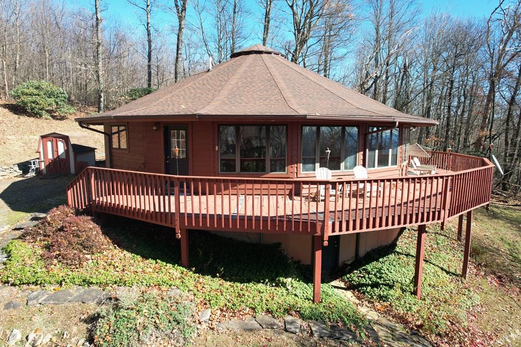 Unique round cedar-sided home located just off the Blue Ridge Parkway between Fancy Gap and Meadows of Dan. This well-maintained 3BR/2BA home offers 1,531 sq. ft. of open living space with abundant windows, a stone gas log fireplace, and a kitchen featuring oak cabinets with all appliances conveying. The primary bedroom includes a master bath, two closets and sliding glass doors leading to the expansive wraparound deck. Two additional bedrooms, full bath, and laundry complete the layout. Exterior features include a large walk-in crawl space, outbuilding, and two combined lots offering additional privacy. Property is in the Elkhorn Acres community, HOA Fees covers Road maintenance, Trash, and Water. Home would make a great primary residence, mountain getaway, or Airbnb. Don't miss out on this move-in ready mountain retreat steps from the scenic Blue Ridge Parkway.