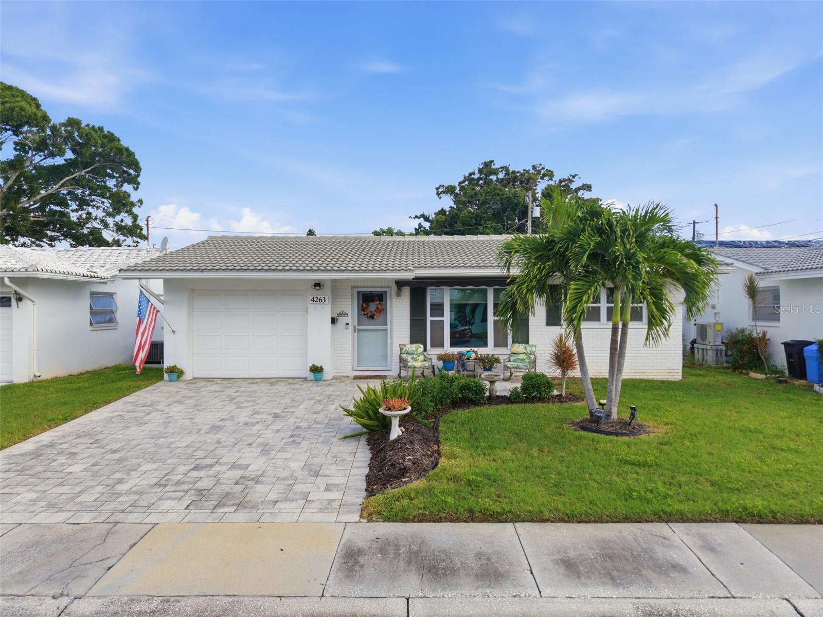Welcome to easy Florida living in Mainlands of Tamarac by the Gulf! This 2-bedroom, 2-bath home features 1,103 square feet of living space, an attached garage and a surprisingly spacious floor plan designed for comfortable everyday living.Step inside to a generous living room that flows into the dining area and kitchen, with a separate Florida room creating even more space to relax, entertain or enjoy the Florida sunshine year-round. Just beyond, a screened porch extends the living space outdoors. The primary bedroom includes a private en-suite bath, while the second bedroom and additional full bath provide flexible space for a variety of needs.The attached garage adds valuable storage and convenience, while multiple living areas provide plenty of room to spread out within an easy-to-manage footprint.Enjoy the relaxed Florida lifestyle Mainlands is known for, with golf right in the community along with a clubhouse, pool and recreational amenities. Spend the morning on the golf course, the afternoon by the pool or simply enjoy everything this established Pinellas County community has nearby.Conveniently located near shopping, dining and everyday necessities, with access to the Gulf beaches and destinations throughout the Tampa Bay area.