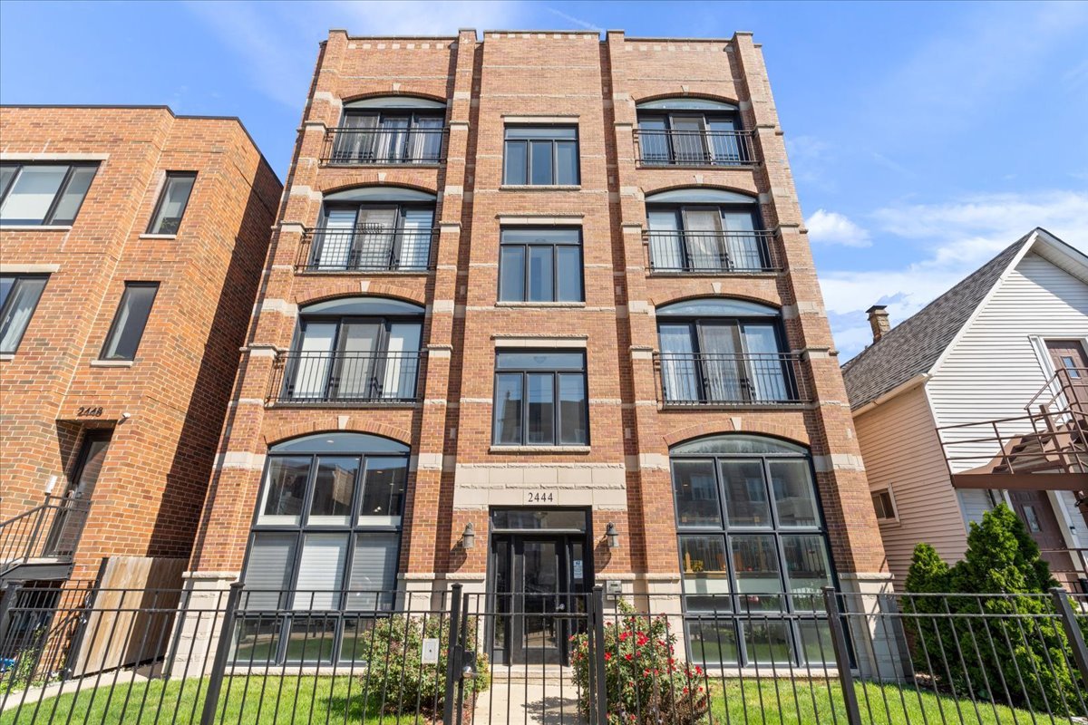 Welcome to your sun-filled sanctuary in the heart of Chicago! This spacious 4 bed/3 bath duplex down lives like a single-family home, offering the perfect blend of luxury and comfort. A dramatic wall of south-facing windows fills the open-concept living space with natural light, highlighting the hardwood floors, crown molding, and cozy fireplace. The chef's kitchen is an entertainer's dream, boasting high-end stainless steel appliances, granite countertops, abundant cabinetry, and an oversized peninsula that flows seamlessly into the living and dining areas. The expansive primary suite is a true sanctuary with two custom closets, a private balcony ideal for morning coffee, and a spa-inspired bath featuring dual vanities, steam shower, and whirlpool soaking tub. The lower level impresses with soaring ceilings, a second wood burning gas starter fireplace, a stylish wet bar, and two additional bedrooms with a full bath and generous storage. Perfectly designed for both everyday living and entertaining! This home offers unmatched space, style, and sophistication in a prime city location. In unit w/d, additional storage unit, and one exterior parking space are all included in the price. Walk out your door to Target, shopping, restaurants, and so much more!