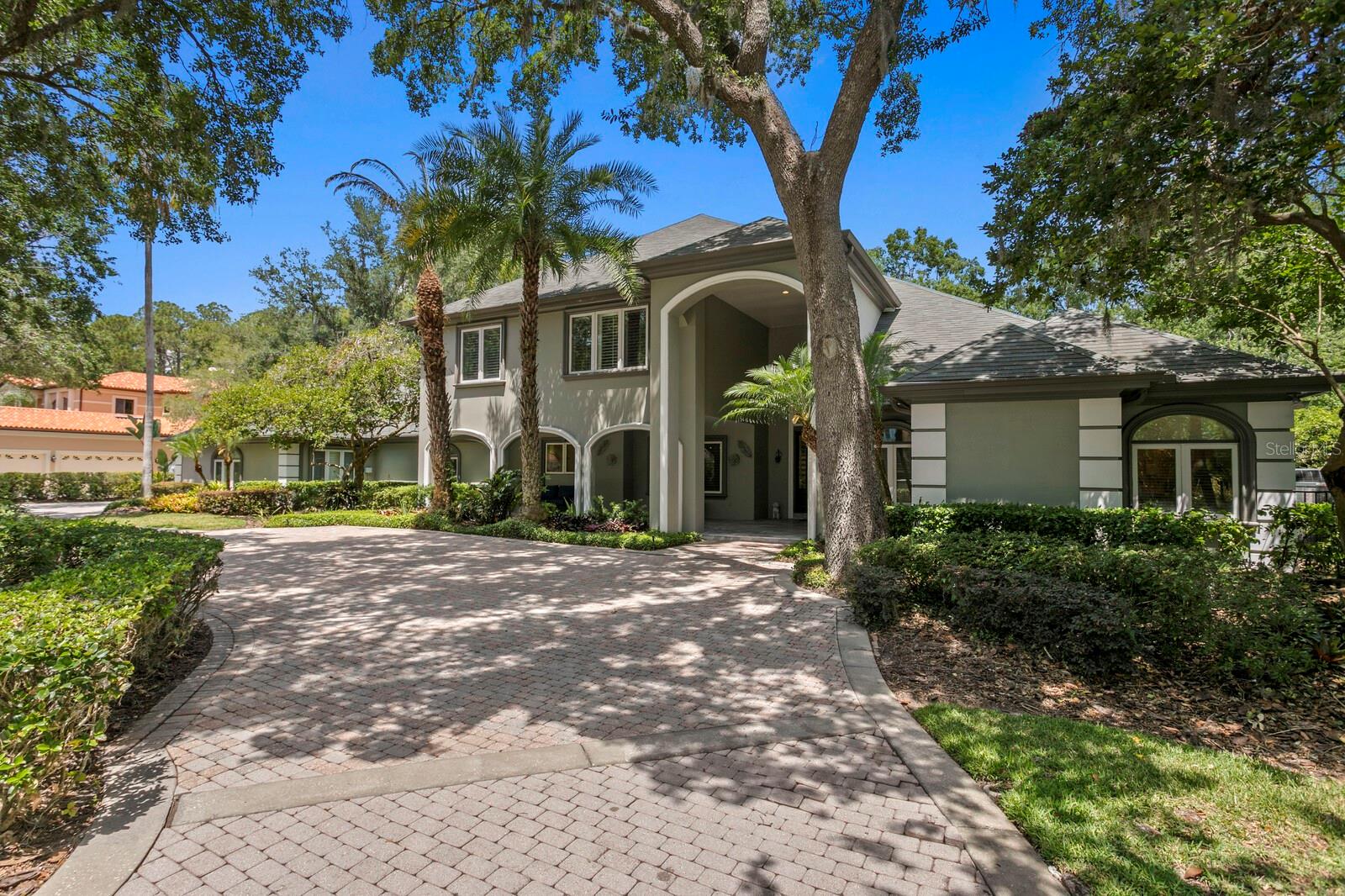 Under contract-accepting backup offers. A Private Retreat with Premier Golf Course Views in One of Tampa’s Most Coveted Gated Communities. Discover an extraordinary lifestyle in The
Reserve, a prestigious 24-hour guard-gated enclave within Tampa Palms. Perfectly positioned along the 3rd hole of the Tampa Palms Golf Course,
this estate offers sweeping fairway views and a serene backdrop of manicured greens that create a truly impressive setting. From the moment
you arrive, the grand semi-circular paver driveway makes a bold first impression, providing ample guest parking and a welcoming front porch
finished in elegant marble tile. Step through the stately entryway into a soaring two story foyer where coffered ceilings, a dramatic great room,
and a richly appointed executive office set the tone for timeless design and functionality. The main home features five spacious bedrooms and
five full bathrooms, thoughtfully designed to accommodate both everyday living and large-scale entertaining. An attached guest house enhances
the property’s versatility, complete with its own private kitchen featuring a gas range, a full bathroom, and a separate entrance. It’s ideal for
extended stays, multi-generational living, or a private workspace. The gourmet kitchen includes granite countertops, extensive cabinetry with
pull-out shelving, stainless steel KitchenAid appliances, and a casual dining nook that overlooks the outdoor living space. The inviting living room
showcases striking open beam ceilings and a cozy gas fireplace, complemented by a built-in wine bar and bookshelves, setting the stage for
effortless entertaining and warm gatherings. The oversized primary suite is a true retreat, complete with a private reading area, wet bar, custom
wood molding and elegant coffered ceilings. It features two walk-in closets with built-ins and a luxurious en suite bathroom with dual vanities, a
large walk-in shower, and a deep soaking jetted tub, perfect for unwinding in. Upstairs, a loft-style seating area connects to three additional
bedrooms and two bathrooms, offering flexibility for guests, family, or creative use. Outside, your private resort awaits. The lagoon-style pool
and spa feature a sun shelf with an umbrella holder and stone fountain, vibrant LED lighting for evening ambiance, and a dramatic stacked stone
waterfall that cascades into the heated spa. Fire bowl accents and flagstone pavers complete the setting, all designed for relaxation and direct
access to the golf course. This home also carries a unique legacy, having once been owned by 14-time Grand Slam tennis champion Pete
Sampras, offering not only luxury but also a touch of sporting history. Conveniently located near I-75, USF, Moffitt Cancer Center, the VA
Hospital, and just a short drive to Tampa International Airport, shopping, dining, and entertainment, this rare offering combines elegance,
privacy, and an unbeatable location.