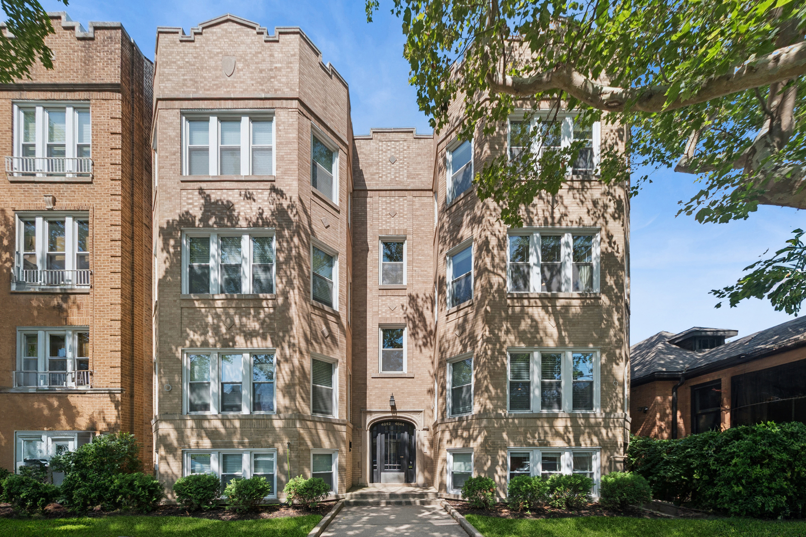 Stunning 3-bedroom, 2-bathroom condo in the heart of Lincoln Square! Converted in 2023, this beautifully renovated residence offers modern finishes within a classic vintage building. The sun-filled living area features an impressive kitchen with white cabinetry, quartz countertops, stainless steel appliances, and an oversized island, flowing seamlessly into the open living and dining space highlighted by a gas fireplace, abundant windows, and exceptional natural light. The primary suite easily accommodates a king-size bed and includes a substantial walk-in closet and a luxurious en-suite bath with heated floors, double vanity, heated towel rack, and walk-in shower. Two additional bedrooms and a second full bathroom with tub provide flexibility for guests, family, or a home office. Additional highlights include hardwood floors throughout, in-unit front-loading washer/dryer, and a spacious private deck just off the unit's rear door. One garage parking space and assigned storage cage are included in the price, along with secure common bike storage beneath the rear deck. Enjoy an unbeatable location just steps from Winnemac Park, Lincoln Square and Ravenswood restaurants and shops, Damen Brown Line CTA station, and everything this vibrant neighborhood has to offer.