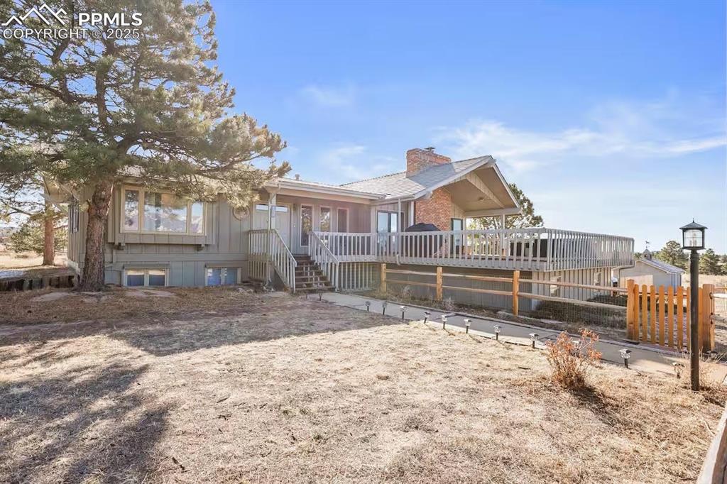 Welcome to your ultimate mountain-view retreat! Hidden away on 3.5 acres with breathtaking, unobstructed views of Pikes Peak and the Rampart Range, this secluded yet centrally located property backs directly up to the Air Force Academy property for added privacy. Situated uniquely outside of city limits and yet within El Paso County and the desirable 80920 zip code of Briargate (and walking distance to the Briargate Promenade), this provides unique zoning opportunities for the prospective buyer. Whether it is to Airbnb the home without any required city permits (as the current owners have done), or to utilize the county RR-5 zoning for livestock and farming, the possibilities are plentiful.

Boasting over 3,200 sq. ft. of living space, the home offers plenty of room for everyone with two full living areas: a great room upstairs with a cozy fireplace, dining space, and full kitchen, plus a downstairs retreat with its own kitchenette, living room, and laundry—perfect for multi-generational living or hosting guests.

Relax on the expansive front deck as you take in the epic mountain views, or take advantage of the brand-new back deck with wheelchair-accessible lift and sidewalk (2024) in the back for those with accessibility needs. The property also includes two large detached storage sheds, two smaller structures, and an attached large 2-car garage. Recent upgrades include a high-quality 50-year roof, newer furnace, water heater, water filtration system, and pump motor for peace of mind. New LVP flooring was installed throughout the upstairs in 2023 and the downstairs in 2024.

Whether you’re looking for a private family retreat, vacation rental investment, or full-time residence, don’t miss a rare opportunity to own a stunning, move-in-ready mountain view oasis.