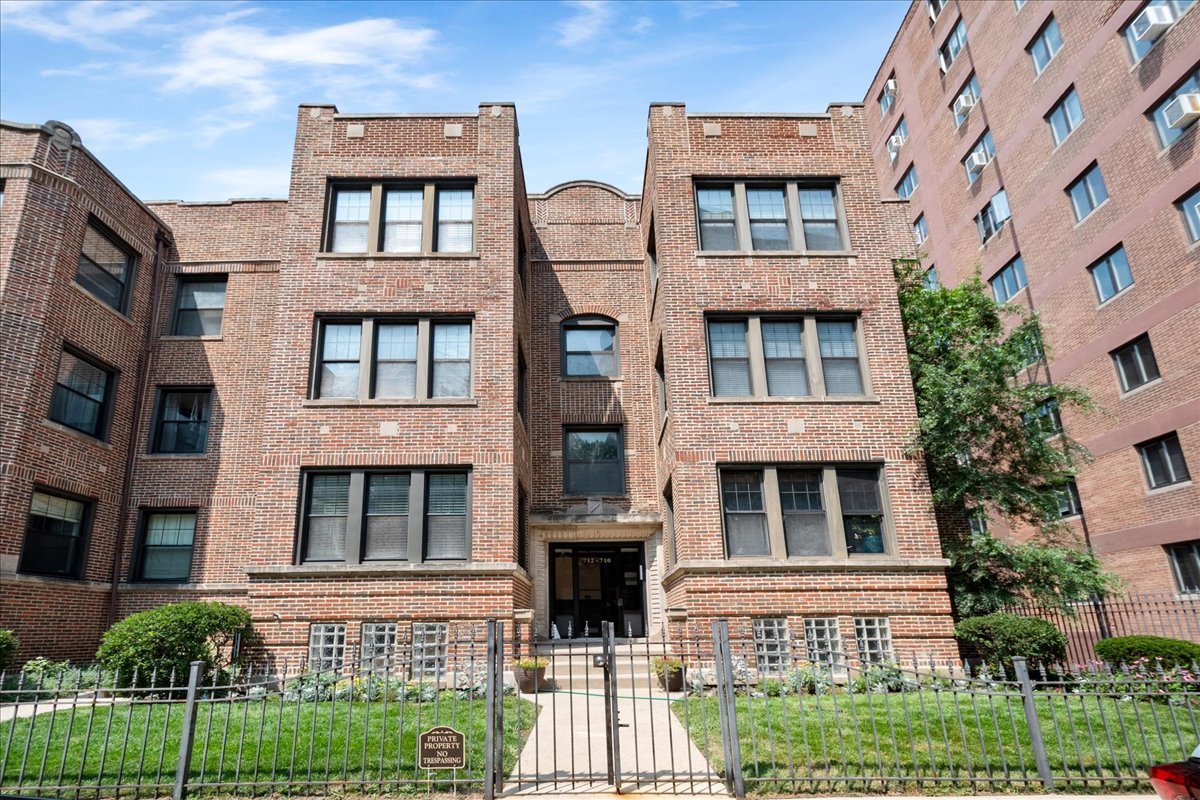 Nestled on a quiet, one-way street just blocks from Lake Michigan, this beautiful 3-bedroom, 2-bath vintage condo offers the perfect blend of classic character and modern updates. Located on the top floor, the unit features hardwood floors throughout and an open, sun-filled living room with a versatile sunroom/office nook-ideal for working from home or relaxing with a book.  The spacious kitchen is outfitted with stainless steel appliances, granite countertops, and a breakfast bar that seamlessly connects to a generous dining area-perfect for entertaining. Step outside to your large private back deck, and enjoy added value with roof rights included.  Convenient monthly parking is available directly behind the building in the Walt Disney Parking Lot for $180 per month, with private entry from the lot into the building. Additional parking is also available nearby at the American Islamic College for $199 per month.  This unbeatable location puts you just steps from the lakefront, Lake Shore Drive, the Red Line, Montrose Beach, and all the shops, dining, and entertainment options of Wrigleyville, Buena Park, and Uptown.