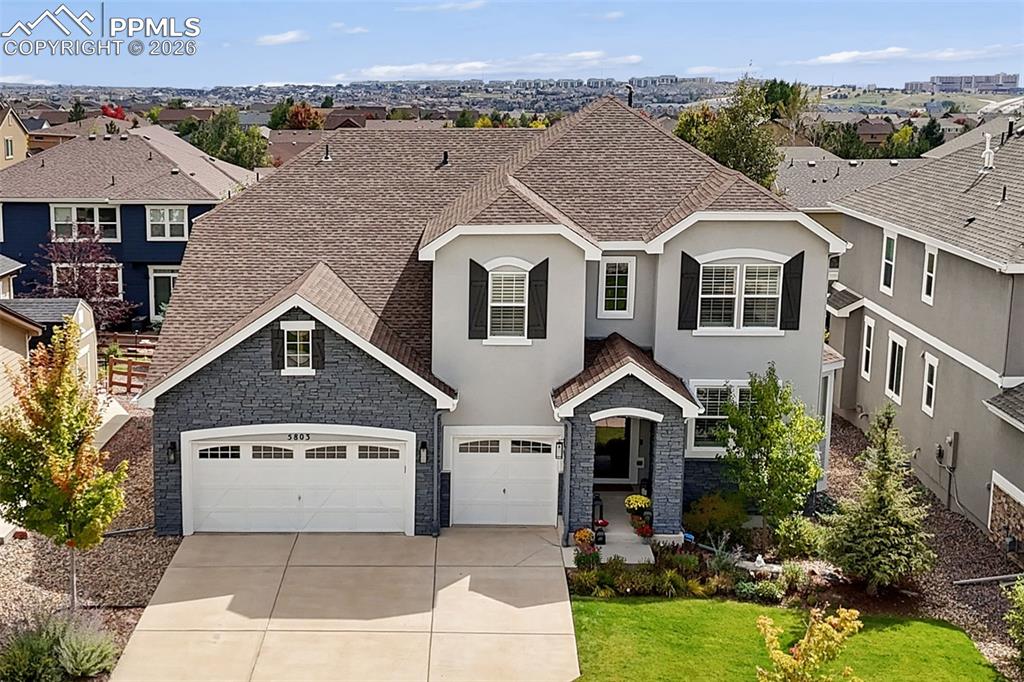 One of the largest floorplans in highly sought after Wolf Ranch, this beautifully finished home offers the kind of space, comfort, and style that makes everyday life feel a little easier and a lot more enjoyable with a busy family. From the moment you walk in, you notice the care and intention behind every space, warm finishes, inviting textures, and rooms that simply feel good to be in.The main level offers a private office and multiple living spaces, including a front room with vaulted ceilings and beams that easily adapts for dining, music, or relaxation, alongside an impressive great room with floor to ceiling windows and a striking stacked stone fireplace.Upstairs and down, there is room for everyone with 6 bedrooms and 5 bathrooms, plus a fully finished basement. The lower level showcases carpet that presents like new, a pool table that remains, and a thoughtfully designed home gym complete with a Peloton Bike, Treadmill, and Inspire Pro Trainer.Out back, the outdoor fireplace, deck and privacy screen make the outdoors feel like an extension of the home, perfect for winding down in the evenings or spending time with friends and family.Located in Academy District 20 and zoned for Pine Creek High School, known for high academic standards and one of the reasons so many families are drawn to the area. Living in Wolf Ranch offers more than just a place to live, you also have access to a private lake for fishing, a community pool for summer days, concerts in the park, and a new clubhouse in the works that will bring even more opportunities to gather and enjoy the neighborhood. It is a home and community that works beautifully for a busy family.
