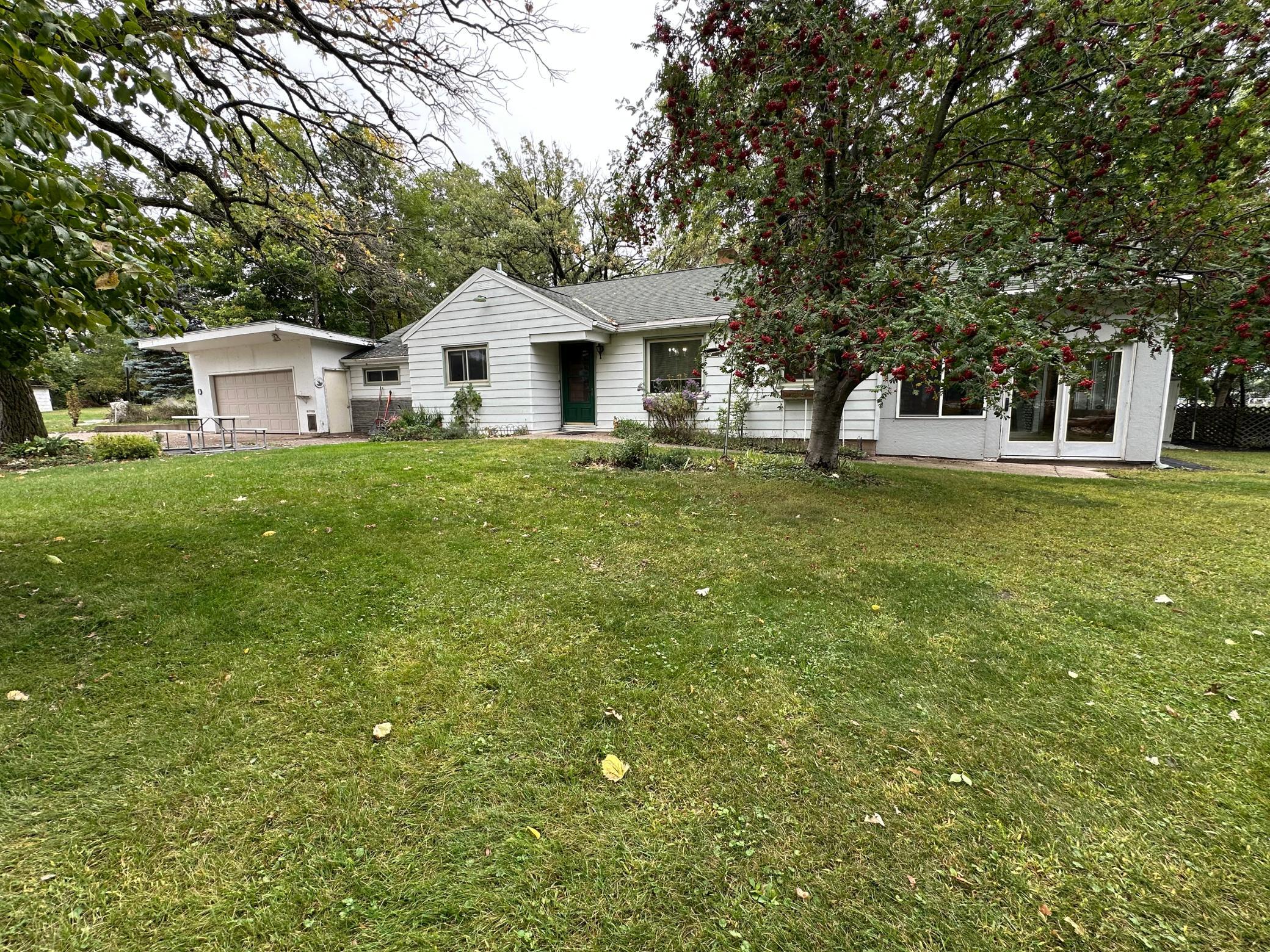Welcome to Grand Lake life! This is a unique opportunity to own a 1.250AC lake place w/56ft frontage, huge shed, and large backlot located just 12 miles from St. Cloud and just 9 miles from Powder Ridge ski resort! This 2+Bed, 2Bath lake home could be a 3 Bedroom by adding a larger window. The main bedroom has access to the full bath with a shower & a double jacuzzi tub. The 2nd bedroom has French doors & double closets. The potential 3rd bedroom has an attached 3/4 bath. Kitchen has granite countertops, tile floors, and big window over the sink. Dining area/living area is a nice open space with woods floors and lake views. Then walk out to the porch on lakeside. This is the best place in the house to relax and enjoy the lake year-round with all the windows and space for gathering. There is an office space, laundry room with storage and utility room that walks out to the attached heated 2 stall garage. BONUS there is the 37x36 shed w/loft to store your boats, snowmobiles, fish house etc., Plus a lean to shed on lakeside for storage of paddle boards, kayaks, and other lake toys. Sandy shoreline w/dock included, large Vintage swing set, & horseshoe pit, birds/nature/privacy, many trees, flowers, and plants in yard. Including: Grape vines (150lbs harvested), pear, apple, cherry, raspberries, asparagus, Hostas, lilacs, peonies, hydrangea bush, sage, pine trees, ponderosa, & more!  Back lot is a great garden spot and has a cellar/storm shelter on it. Come see what this place has to offer!