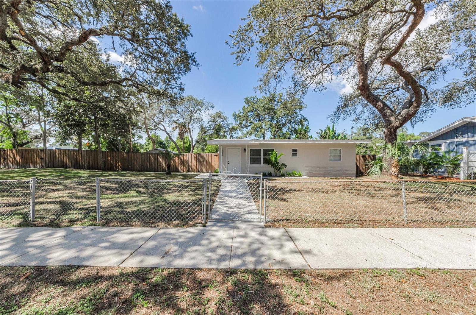 Super Cute 2 Bedroom, 2 Bath block home perfectly situated on a spacious DOUBLE LOT with NO HOA in beautiful Tarpon Springs!!  Surrounded by mature trees, this property offers both shade and privacy, creating a peaceful setting to call home.  Inside, you'll find a freshly painted interior featuring new stainless-steel appliances, quartz countertops, and a gorgeous master bath.  The home also boasts a new roof, new water heater, new septic system with a 1-year warranty, new luxury vinyl flooring, new cabinetry, beautiful, updated baths and more - giving you peace of mind for years to come!  With its ideal location and plenty of room to make the outdoor space your own, bring your business there, park your work trucks, this home has endless potentials.  There is a huge, enclosed storage area off the back of the house, an RV Covered area or park your cars under it.  Whether you're a first-time buyer, downsizing, or looking for a great investment, this one checks all the boxes.  Close to the world-famous Tarpon Springs Sponge Docks, dining, shopping and the beaches are all close by. Don't miss the chance to own this Tarpon Springs Gem!