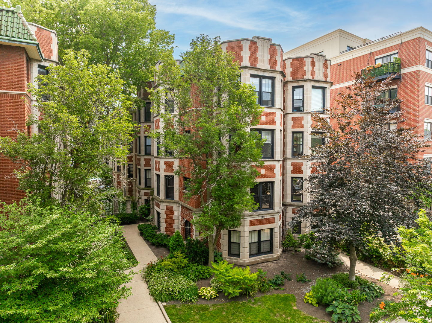 Enjoy this HUGE, beautifully appointed 3 bed / 2 bath duplex penthouse that includes exclusive water rights just steps from the lake. Enjoy private pier access for kayaking, paddle boarding, or simply soaking in the views-plus a deeded heated garage space next door. Inside, you'll find high-end finishes throughout: custom walnut cabinetry, marble backsplash, granite counters, hardwood floors, and ample built-in storage. The main level features a light-filled living room with wood-burning fireplace, a den/family room, full bath, and a stunning chef's kitchen with a large dining area and custom window seat. Step out to your back deck-perfect for grilling. Upstairs, the spacious primary suite boasts inviting bay windows and a walk-in closet. Two additional bedrooms offer flexibility-one with built-in bookshelves and one ideal as a sunlit home office. A top-floor back deck and wet bar with lake views is the perfect spot to unwind. Additional perks include 2 dedicated storage spaces, internet and Xfinity cable package included in monthly assessment, kayak/paddleboard & bike storage, a ButterflyMX intercom system, and proximity to the lakefront path, a dog park, and all the best of Rogers Park living.