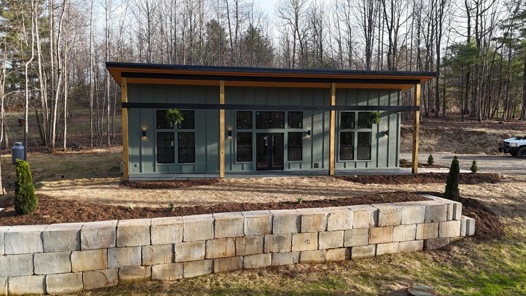 Welcome to your new construction home, right outside of Galax, situated on 1+ acres next to the new river trail and new river outfitters. This new home balances modern luxury and open floor concept with high end finishes throughout. Certified Energy Star rated, featuring thermal windows, the home is designed for year-round efficiency with 4 separate Mitsubishi mini split units + heat pumps and Generac switch. The home truly shines outdoors, offering multiple inviting living spaces with a beautiful front porch, natural beams and a large lawn for activities. Professionally installed hardscape using belguard stone to elevate the outdoor spaces and landscaping that will fill in overtime to provide this home a natural look that will blend into its surroundings. This home was thoughtfully built to offer enough space for a future garage with plenty of space for additional parking. Inside, you will find a warm entry foyer with thoughtful design that leads into an open kitchen and living area. Beautiful cabinets and backsplash add contrast to the natural tongue and groove ceiling, quartz countertops along with new GE appliances throughout really make this kitchen stand out. The living area offers a large media wall with modern 48” gas fireplace, mantle, bookshelf and flush Tv mount. The primary suite offers a large bathroom with a double sink and floor to ceiling granite tile in the shower. The other two bedrooms are spacious with high ceilings and plenty of closet space. The second bathroom offers a bathtub with granite and marble to the ceiling with shiplap accent.