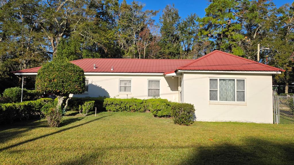 This solid block residence presents a fantastic opportunity for those looking to add their personal touch. Featuring three bedrooms and a versatile office that could easily serve as a fourth bedroom, this home offers flexibility for growing families or work-from-home professionals. The durable metal roof ensures longevity and peace of mind, while the inviting backyard promises outdoor activities or simply relaxing. Inside, unleash your creativity as you embrace the chance to update and customize to match your style with cosmetic remodeling of the kitchen, bath, flooring, light fixtures and paint through the FHA 203k program. Conveniently located close to local schools, parks, hospital and dining options, this property is perfect for those seeking both comfort and convenience. Don't miss out on making this house into the perfect home that reflects your vision! Whether you're an investor or a first-time buyer ready to personalize every detail, this gem is waiting for you in Thomasville. Schedule a tour today and explore all its potential!