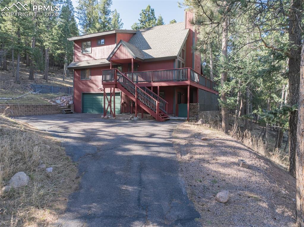 This mountain property offers vaulted ceilings, expansive windows, and a stunning stone fireplace that anchors the main living area. The kitchen features fantastic cabinetry, updated appliances, and a functional layout ideal for everyday living. Natural light fills the home, creating a bright and comfortable atmosphere throughout. The flexible floor plan includes a basement bedroom with an attached half bath and its own fireplace, offering additional living or guest space. The main level showcases natural wood flooring and a beautiful stone fireplace, while the upper level features a private suite complete with a kitchenette and access to a wood balcony—perfect for enjoying the secluded scenery. Recent updates include a newer HVAC system with a built-in UV sanitizing element. Outside, a spacious wraparound deck provides excellent outdoor living space in a peaceful, wooded setting. Located in Woodland Park, this property offers easy access to outdoor recreation, scenic surroundings, and the charm of mountain living, all while being a short drive to the great city of Colorado Springs!