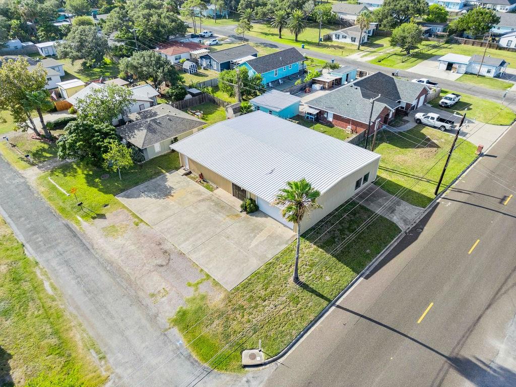 This versatile 4,500 sq. ft. multi-use commercial building offers endless possibilities—ideal for retail storefront with display windows, daycare, spa/gym, professional office space or residential...possibilities are endless. The property features two impressive showrooms, one just over 800 sq. ft. and the other approximately 950 sq. ft., perfect for product displays or open workspace.  Its warehouse of just over 875 sq. ft. provides convenient storage or expansion opportunities. The layout includes multiple private offices, an inviting reception area, convenience restroom, and ample on-site parking for staff and clients. Adding to the value is a custom-designed one-bedroom apartment with rich woodgrain vinyl flooring, impressive aspen wood ceilings and wainscoting, granite countertops, and a full bath with walk-in shower—perfect for on-site living or additional rental income. Located in a high-traffic area with excellent visibility and easy access to South Rockport, downtown Rockport, Business 35, and the 35 Bypass, this property offers location, flexibility, and functionality all in one.