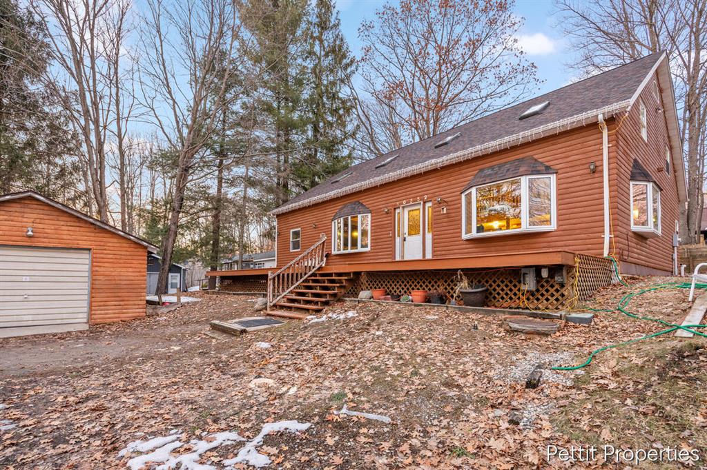 Rustic elegance meets northern tranquility! This 5 bed, 3 bath log chalet rests on a 0.55 acre lot directly across from Elbow Lake. As you walk in the front door you're met with 21 foot cathedral ceilings supported by two stunning natural timber beams. The open layout features skylights, knotty pine finishes, and a spacious kitchen with stainless steel appliances. Within the last three years the roof was replaced and a brand new Lochinvar on demand boiler system was installed. Step outside to the full length front deck or rear deck, ideal for cookouts and starlit nights. Enjoy deeded access to the private beach and boat launch areas. Surrounded by state land, ORV and snowmobile trails, this home is a haven for outdoor enthusiasts. Approx. 2,775 sq ft, propane baseboard heat, and high speed internet availability provide year round comfort. You are never far from the necessities with Walmart's delivery service! Experience true up north living, schedule your private showing today!