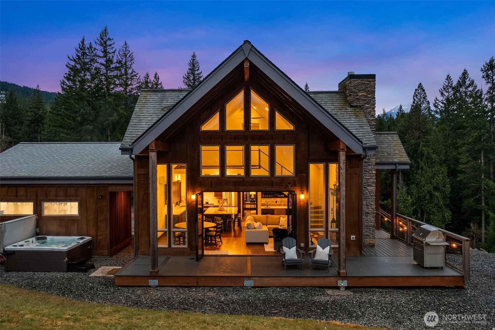 Welcome to Hideaway, Packwood’s premier gated neighborhood with arguably the best Mt. Rainier view in town. Sitting proudly on a shy half-acre is this stunning 2019 chalet. It features a NanaWall of glass facing the spectacular Mt. Rainier view, creating a seamless indoor-outdoor flow on to the composite low-maintenance wrap-around deck. The main level open-concept great room showcases a floor-to-ceiling fireplace that warms the room with the flip of a switch. The kitchen is equipped with a Dacor gas range and matching stainless-steel appliances. A hammered apron-front copper sink serves as a striking focal point, pairing beautifully with the granite countertops. Don’t miss the wet bar with wine fridge and matching hammered copper sink. The primary suite offers another gas fireplace and a 5-piece bath with clawfoot tub. Upstairs, you’ll love the bunk room with west-facing Cowlitz River Valley views. The third bedroom is adjoined by another full bath. The exterior is clad in cedar shake and stained board and batten siding, establishing a timeless aesthetic. The freshly paved asphalt drive welcomes you to the attached two vehicle carport with a beautiful tongue and groove ceiling and a convenient sizeable storage room for your recreational gear. Less than a mile from the shopping, dining, and entertainment of Packwood’s town center and 25 minutes from White Pass and Mt. Rainier National Park, this durable and timeless chalet is offered furnished for your immediate enjoyment.