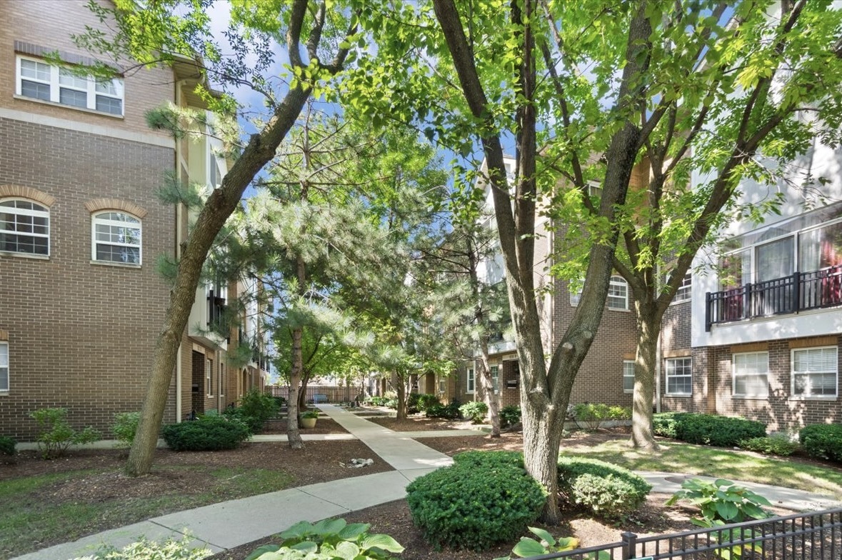 This exceptional Brick Townhouse is perfectly nestled in a picturesque, tree-lined courtyard in one of the most coveted West Bucktown neighborhoods. This charming home offers 4 bedrooms, 3 full bathrooms, 2 Car Attached Heated Garage and charming private outdoor roof space. Upon entering the main level, one's eye immediately gravitates toward the large floor to ceiling windows which frame lovely views of the lush foliage courtyard. The main level is located on the second floor and is brilliantly designed with an open layout, offering a seamless floor plan between the living room, dinning area & kitchen. This layout is perfect for busy family life and entertaining guests. The entire main level has Gorgeous Hardwood flooring, the living room is anchored by a beautiful fireplace (wood burning with gas starter) and built-in cabinetry. Picture cozy winter evenings by the fireplace, sharing laughter and friendly competition over a board game. The kitchen features an island with bar seating, stainless steel appliances, granite countertops, stainless steel sink with large window above pouring natural sunlight into the home. In addition there is a spacious pantry closet with additional storage, adjacent outdoor balcony for grilling and laundry closet area with large side by side washer and dryer. The dining area is ideally located in between the kitchen and living room for easy access. This home's third level has an ideal floor plan consisting of the primary en-suite bedroom, another large bedroom, full bathroom and a linen closet. A true private sanctuary, this tranquil primary suite offers a retreat of relaxation. A large window overlooks a gorgeous tree, inviting nature in and filling the space with serene light. Additional features include, Vaulted ceilings with a ceiling fan, 2 separate closets, a private spacious bathroom offering large sink cabinetry with 2 sinks, generous cabinet storage space and a deep bathtub; the perfect place to to unwind & relax at the end of the day. The second bedroom is also large and spacious enough for 2 people to share this room. A bright & colorful custom wall is sure to be loved by many. There is a large wall of closets, with separate doors so each person could have their own separate closet space. Directly next door to this bedroom is a full bathroom with large sink vanity and a linen closet just down the hall. The top floor level is currently used as a family room/office, the ideal place to relax, work or entertain with direct access to your private roof deck. This deck is the perfect space to have a BBQ and spend relaxing time with family & friends. Brand NEW Flat roof was just installed. The first level of this home offers an ideal home office or extra bedroom space. This level also has a fully renovated bathroom, closet space and 2 car attached garage with storage space. This home has dual zoned HVAC with Nest. This West Bucktown home is in a Fabulous Location and literally just steps from the Bloomingdale 606 Trail (Bike & running path). The Lucy Flower Park is just across the street on the corner, a beautiful playground where neighborhood children love to get together and have fun! Close to Parks, Public Transportation, within minutes of the Western Blue Line, there are many restaurants & cafes to enjoy nearby as well as coffee shops, Small Cheval, Margies Candies, Cermak Produce, Starbucks and more! Impeccably designed, this home beautifully blends modern luxury and flexible living space, perfect for today's lifestyle. A true sanctuary, ideal retreat for city living at its best!