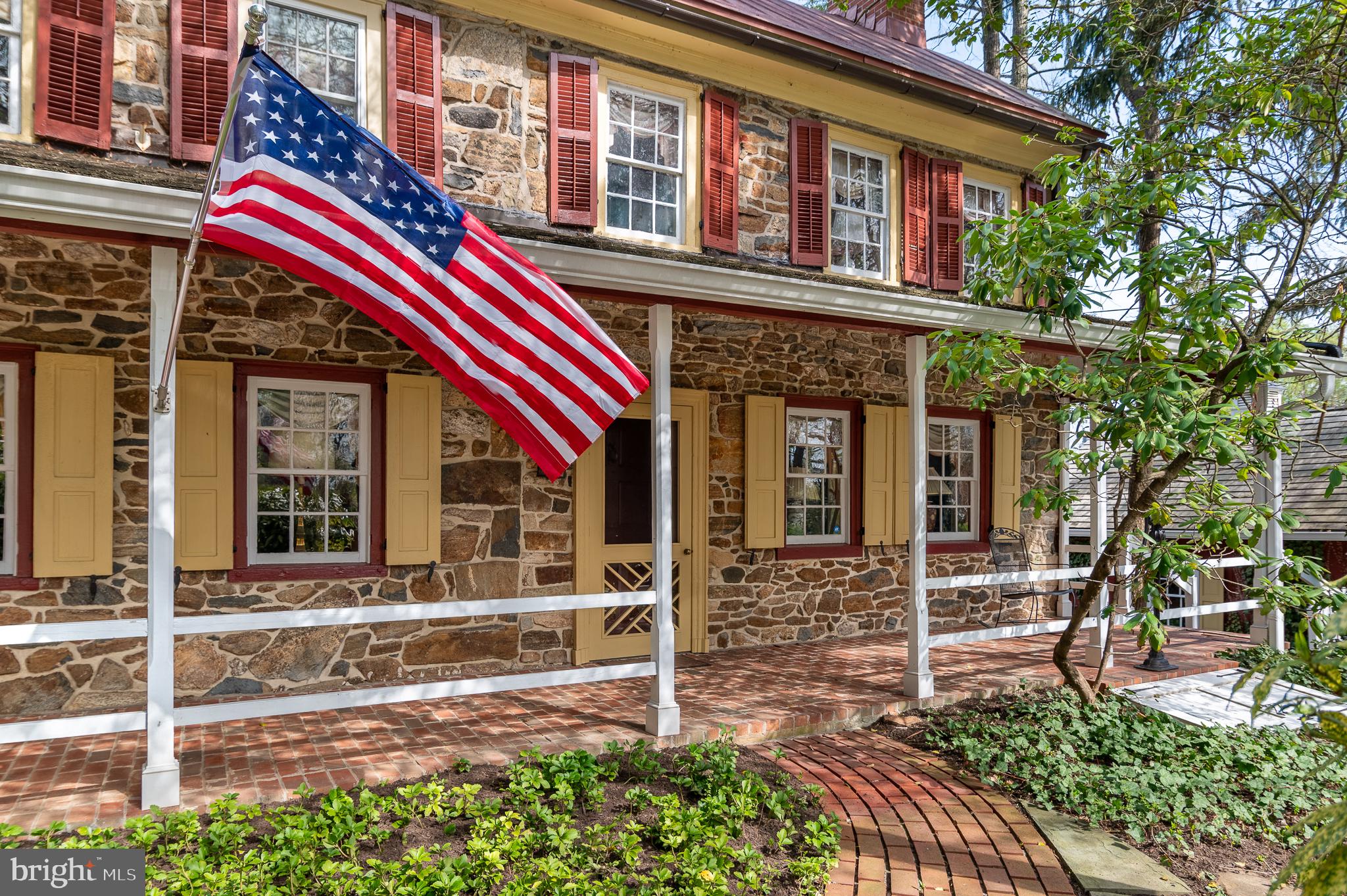 Colonial charm meets timeless character in Chester Springs at Saint Matthews Place! Located at 1169 Saint Matthews Road in West Vincent Township, this one-of-a-kind historic home dates back to the 18th century and beautifully blends its original architecture with thoughtful additions completed in 1980 and the 2010. Set on 7.4 acres, the 3,614 square foot  home features a front sitting patio and a large enclosed brick patio overlooking the backyard and pastures—perfect for entertaining and tranquility. The home offers 3 bedrooms, 3 full baths, and 2 half baths, with both levels showcasing distinctive architectural character enhanced by hardwood and tile flooring throughout. A bright sunroom with floor-to-ceiling windows/sliding doors and a classic brick floor overlooks picturesque scenery. A spiral staircase leads to a loft featuring a striking floor-to-ceiling built-in bookcase. All three bedrooms include ensuite bathrooms—the loft offers a half bath, while the remaining two feature full baths. A third full bath is on the main level off the living room, complete with a standing shower and separate bathtub with a tub rail. The home also includes convenient laundry on both the main level and in the basement.Equestrian enthusiasts will appreciate the impressive outdoor amenities, including a large bank barn, built with local stone that features 10 stalls, a tack room, a blanket room, a tool room, a half bath, and extensive upper-level storage for feed, farm equipment or carriages. The barn opens directly into one of two pastures, which together feature four run-in sheds and a feeding trough. The property also includes a newer oversized three-car garage, along with two separate driveways—one serving the home and one the barn. This exceptional property offers timeless character, functional space, and a rare opportunity to own a piece of history.