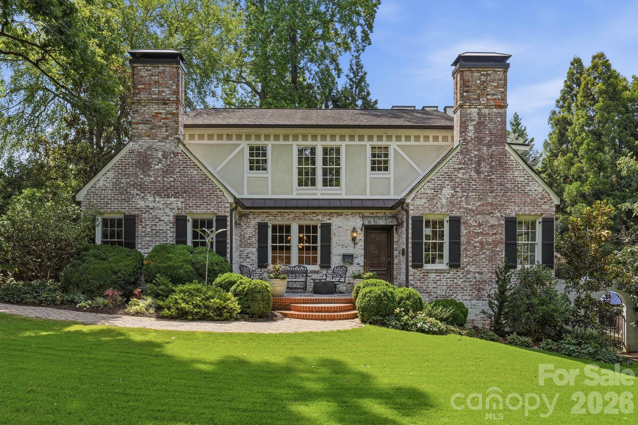 Within Plaza Midwood’s most exclusive enclave sits one of the neighborhood’s signature properties. Offering unmatched serenity & privacy within Charlotte’s urban core, this nearly .6-acre English Country estate embodies the character that defines Plaza Midwood.Rarely do homes of this distinction come available in the shadows of Charlotte Country Club. Meticulously renovated by its two most recent owners, including a prominent Charlotte builder, 2700 Belvedere has been featured on the Plaza Midwood Home Tour, Home Design Decor and Southpark Magazine.The vintage Parisian front door clad in Cast Iron sets the scene, while a custom Soapstone fireplace defines the spacious Living Room. Hand woven velvet wallpaper and solid wood wainscoting elevate the Dining Room. These spaces harken to the home’s heritage with the original wood picture molding and baseboards.In the kitchen, thick slab Quartzite countertops accent the 48’’ Wolf Range and Sub-Zero refrigerator. Glance over the kitchen sink to your English Garden highlighted by a Koi Pond and mature landscaping. Two of the home’s five bedrooms round out the main living area. The upper level features a versatile bonus room with full bath that can serve as a bedroom, media area or additional entertaining space. Continue up the stairs to your nursery/office /5th BR with attached full bath and into the Primary Suite, highlighted by a massive walk-in shower & closet with dedicated washer/dryer. Sip morning coffee on the patio with the tranquil feel of the Koi Pond & Gardens.The resort style outdoor space features a 20,000-gallon heated saltwater pool with swim jets & built-in hot tub. Relax on chilly nights in front of the outdoor wood burning fireplace while cooking on the built-in gas grill. Retire to your lower-level entertaining space and enjoy wine from the 148-bottle cellar in front of the gas log fireplace. Guest, tenant or multi-generational options abound with the 596 sq ft guest cottage, complete with kitchen, living, full bath, laundry, loft style bedroom & private patio.2700 Belvedere offers the rarest of opportunities in Charlotte Real Estate; exclusive location, seclusion, unmatched space & designer curated finishes.