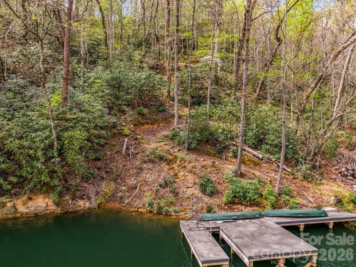 Two lakefront lots combined for a fantastic 2 acre build site on a quiet cove in Rumbling Bald Resort. New dock - see pix.  Good potential for a lakefront home with an already existing dock and access path down to the lake.  This prime location is a short drive ie 3 min from club / pools/ amenities on Rumbling Bald’s Quail Ridge / Dogwood / Water Pointe lake cove. This IS THE spot for a luxury lake lifestyle.  Rumbling Bald resort on Lake Lure is voted one of the best private lakefront communities in WNC. With a gated/staffed 24/7 entrance, property owners can enjoy a care-free self contained resort lifestyle on beautiful Lake Lure. Enjoy boating from your own boat house, dock, or the club marina. Play on championship golf courses, tennis, pickleball, outdoor and indoor pools, private sandy beach, on-site restaurants, salon and spa, year round indoor pool, kids activities and camps, mini golf, lazy river, hiking, fishing… plus the town of Lake Lure and infinite outdoor day trips to nearby charming mountain towns and national parks. Convenient to Asheville, Hendersonville, Charlotte, and Greenville. A 5 BR home located across the road from this lakefront property is available from the same sellers. See separate listing for 556 Quail Ridge Boulevard. Home plus lakefront could pair fabulously to create a 5+ acre package. Buyers to confirm resort membership rules and fees.