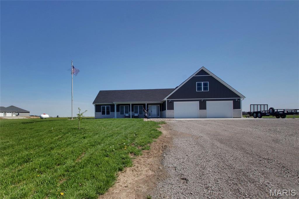 Welcome to this stunning 2024 built ranch home in New London, offering the perfect blend of modern design, functionality, and peaceful country living. Situated on 3 acres this 4 bedroom, 2 bath home provides over 2,000 square feet of thoughtfully designed space. Step inside to an open concept layout highlighted by vaulted ceilings and durable, low maintenance luxury vinyl plank flooring throughout. The light and bright custom kitchen is the heart of the home, featuring ample cabinetry, stone countertops, a massive central island perfect for gathering, and an impressive 5x9 walk-in pantry ideal for storage and organization.The private primary suite is a true retreat, complete with a spacious walk-in closet and a beautifully designed oversized walk-in shower. A split bedroom floor plan offers two additional well sized bedrooms and a full bath on the opposite side of the home, while a versatile bonus room above the oversized attached two car garage serves perfectly as a fourth bedroom, office, or flex space. You'll also fall in love with the convenience of the generously sized main floor laundry room. Enjoy outdoor living with a 24x28 poured concrete patio and fire pit area perfect for entertaining or relaxing under the stars. And you wont have to worry about privacy as the current owner has planted over 65 evergreens to surround the property and create peaceful seclusion for years to come. With a slab foundation, modern construction, and room to spread out, this property delivers comfort, efficiency, and style in a serene country setting.