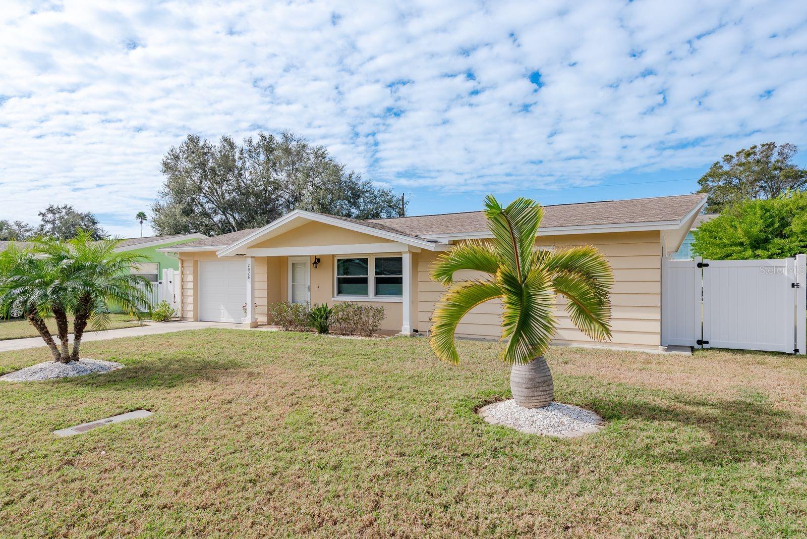 This move-in ready home is perfectly situated between vibrant, downtown Dunedin, less than two miles away, and Honeymoon Island State Park, just three miles away.  There is no HOA.  This home features two bedrooms, two bathrooms, a one-car garage and an open floor plan. The kitchen is light and bright with beautiful quartz countertops and tons of extra cabinet space. You will love the flexibility of the innovative top-down bottom-up shades in the living room.  The dining room provides you with views of the beautiful and spacious back yard.  The primary bathroom features a shower with a tub. The second bathroom is in the garage and has a shower.  The back yard is fully fenced with a large screened patio. For your outdoor recreational equipment, there is a storage room accessible from the back yard.  You will appreciate the pride of ownership and updates. The kitchen appliances,  cabinets and countertops were all replaced in 2025.  The HVAC, washer, dryer and tankless water heater were all replaced in 2024.  The fences were replaced in 2023.  The 200-amp circuit panel was installed in 2023.  The impact windows, impact garage door and impact exterior doors were all installed in 2021.  The roof was replaced in 2016.  This home is located in the Dunedin Golf Cart Zone and is two blocks from the Pinellas Trail.  The Dunedin Golf Club, Hammock Park, Dunedin Fine Art Center, Highlander Aquatic Complex are all very close. Beyond Dunedin, you will find world-famous Clearwater Beach and the Clearwater Marine Aquarium. Schedule your showing today so you can start living the Florida dream.