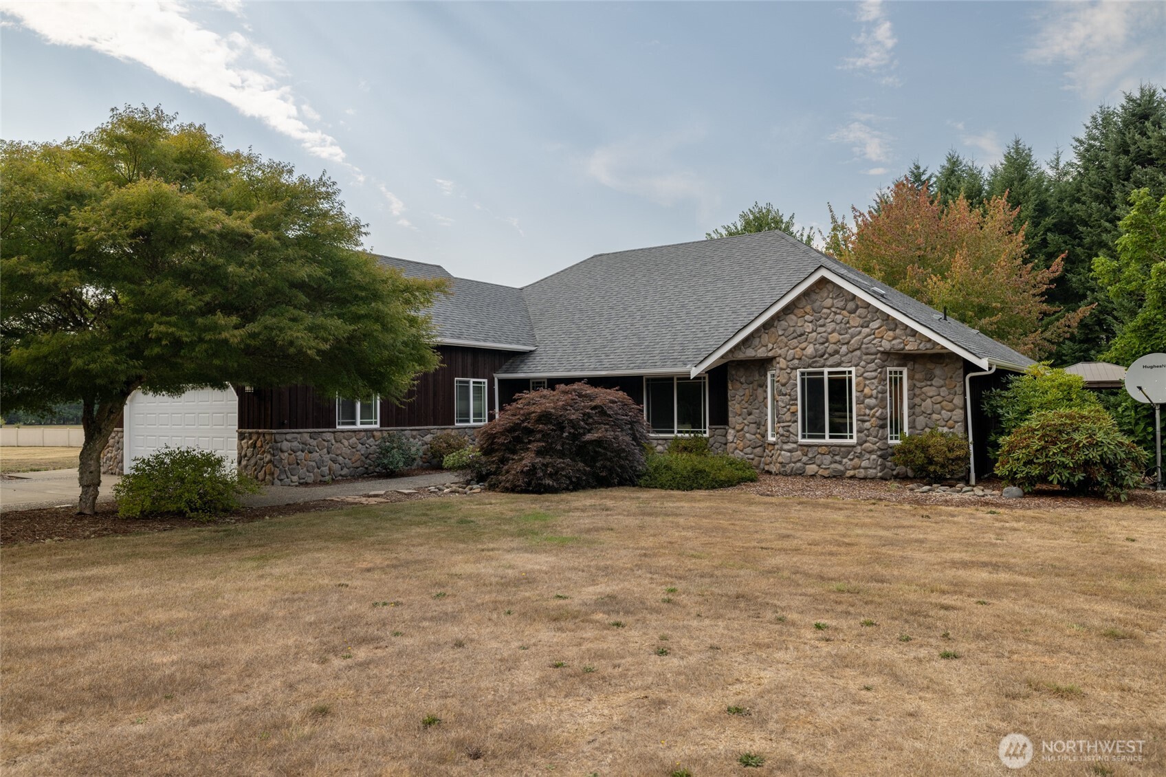 Gorgeous 3200+ sq. ft. single story 3 bed/3 bath home sits at the end of a private road. 5 flat acres with 1.5 ac. of timber, a 36 x 48 shop, green house, chicken coup & garden. Exterior recently painted & stained. Stunning rock work throughout the interior & exterior.  Large living room w/gas fireplace, vaulted ceilings, double French doors opening to a large patio, wildlife & a covered hot tub. Kitchen has tile counters & floors, lg. pantry, stainless appliances & plenty of space to work.  Second living room area opens up to a dining room giving plenty of room to entertain. Large primary bedroom w/walk in closet, 5 piece bath, sitting area & a door to that beautiful patio. Room above garage would make a great game room, gym or office.
