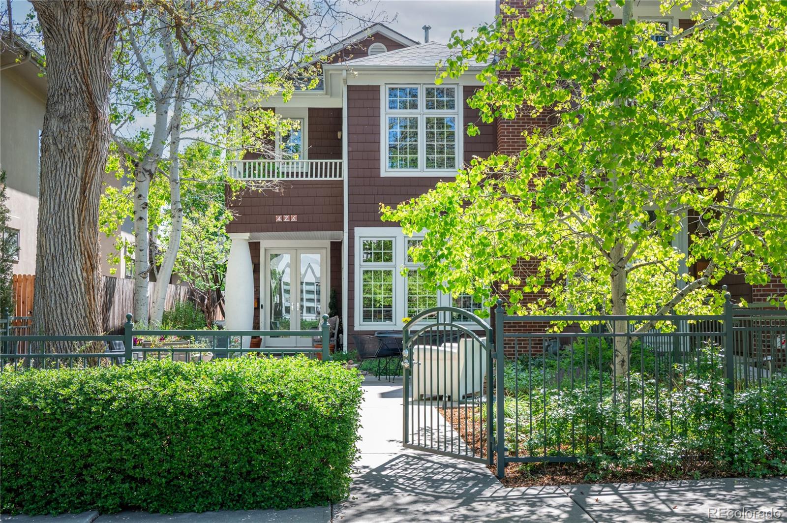 Enjoy easy and elegant living in this lovely Contemporary Craftsman inspired townhouse designed by noted architect Mark Adcock. Situated on a beautiful block in a prime Cherry Creek North location with easy access to all the restaurants and shops of Cherry Creek, yet just out of the fray with plenty of street parking for your guests. The wonderfully flowing floorplan has the perfect amount of space! The Living/Dining Room easily accommodates a large dining table and cozy seating area for all your entertaining needs and has delightful views over the patio and trees. Cook up a fabulous feast or just make snacks in the gourmet Kitchen with honed limestone counters, high end Bosch and Sub Zero appliances, five burner gas range, a generous island with counter seating, and Kitchen eating nook. Relax in the inviting Great Room with its welcoming fireplace, then retire to your peaceful and secluded Primary Suite with large walk-in closet and gorgeous marble five-piece bath. Two more ample Bedroom Suites, each with their own full bathroom and walk-in closet, create many options for use and provide plenty of space and privacy for their occupants.  The basement includes a spacious Family Room with an oversized egress window letting in lots of light. High ceilings and exquisite touches throughout, including cherry stained oak floors on the main level, custom woodwork, and plantation shutters and a plethora of large, divided windows ushering in abundant natural light.  Exceptional outdoor spaces include an expansive front patio shaded by stunning mature trees and a side patio with French doors opening from the Kitchen/Great Room, perfect for peaceful morning coffee with the birds. Very little outdoor maintenance is required, making this an ideal lock-and leave home. The oversized attached two car garage is an extra bonus. Come live the lifestyle you've been dreaming of!