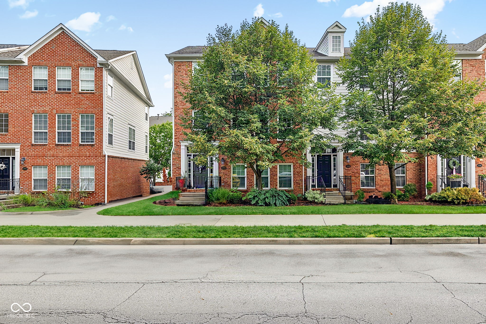 Discover a ONE OF A KIND remodeled townhome at Providence at Old Meridian! Built in 2004, this 2234 sq ft home has had a wall removed for a completely open concept. The updated kitchen has 48" solid wood cabinets, quartz countertop, center island, pot filler, a direct-plumb line for your coffee maker, and a smart refrigerator. A chandelier has been added to the new dining space along with a feature wall. The living room is open from front to back and has a new striking wood-facade fireplace. The washer and dryer have been moved to the primary bedroom closet, which has a beautiful sliding black closet door and feature wall. The primary bath has a dual-vanity and rain head shower.  The lower level has large wet bar with concrete countertops, brick backsplash and brick walls, perfect for entertaining. The oversized heated garage offers an outlet for an electric car and ample storage. The home has 3 bedrooms, 2 full bathrooms, and 2 half bathrooms with vinyl plank flooring throughout.  The community offers so many amenities with low HOAs. This updated townhouse presents an exceptional opportunity to embrace a vibrant lifestyle in Carmel. Schedule your appointment today! This one won't last! The home includes all new windows and sliding glass door in 2024. New water heater in 2026. The roof was replaced in 2018, water softener 2019, all appliances 2019. The garage offers a heater, ceiling storage units to stay, and a 220 volt outlet for electric car if needed.
