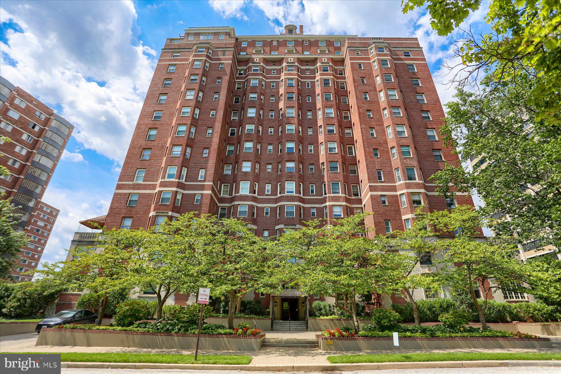 Set on the 11th floor of The Warrington, one of Baltimore’s landmark buildings constructed in 1928 in the Georgian Revival style, this light-filled two-bedroom, two-bath residence pairs classic architectural character with modern comfort in a building with just four homes per floor. A black-and-white tiled foyer introduces expansive living and dining rooms featuring gracious proportions, parquet floors, refined millwork and elevated views. The renovated kitchen offers granite countertops, new stainless-steel appliances, gas cooking and an adjacent laundry room. The spacious primary suite includes generous closet space and a marble bath with a jetted tub and separate walk-in shower. New room-by-room heating and cooling units provide individual temperature control. One garage parking space on the building’s second level conveys, with valet service available. Additional conveniences include dedicated unfinished basement storage with accessible shelving and access to wine storage. Residents enjoy 24-hour front-desk service, full-time building management, a fitness room and a beautifully landscaped outdoor terrace.